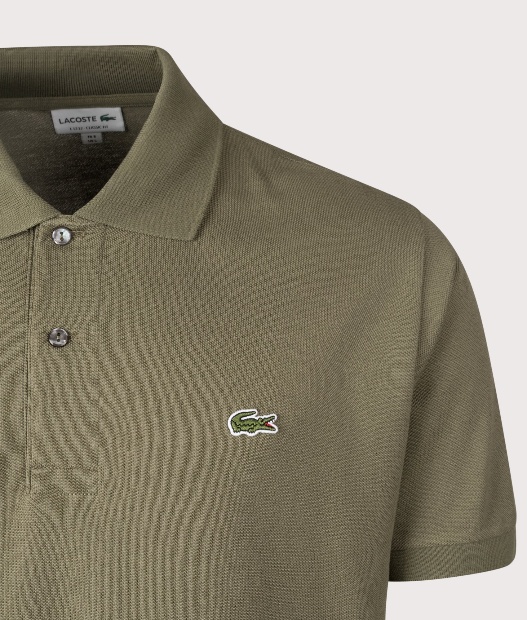 Lacoste Classic Fit L1212 Croc Logo Polo Shirt in Khaki Green at EQVVS Menswear. Detail shot.