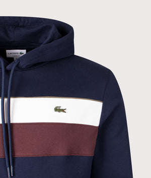 Colourblock Hoodie in Navy Blue/Flour-Red Vermouth. | 100% Cotton | Lacoste | Shot at EQVVS |  Front detail shot