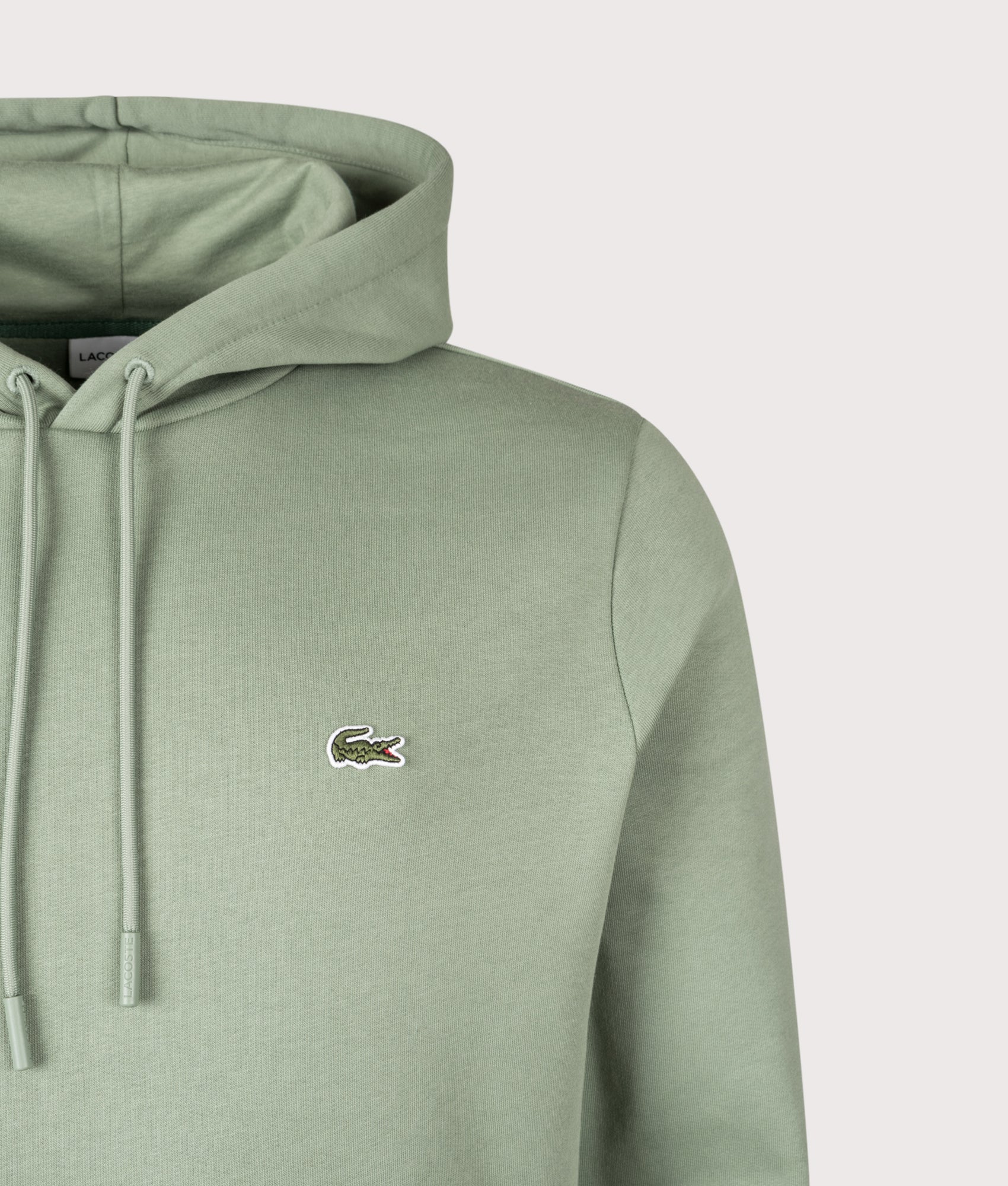 Lacoste Brushed Fleece Hoodie in Thyme at EQVVS Menswear. Detail shot.