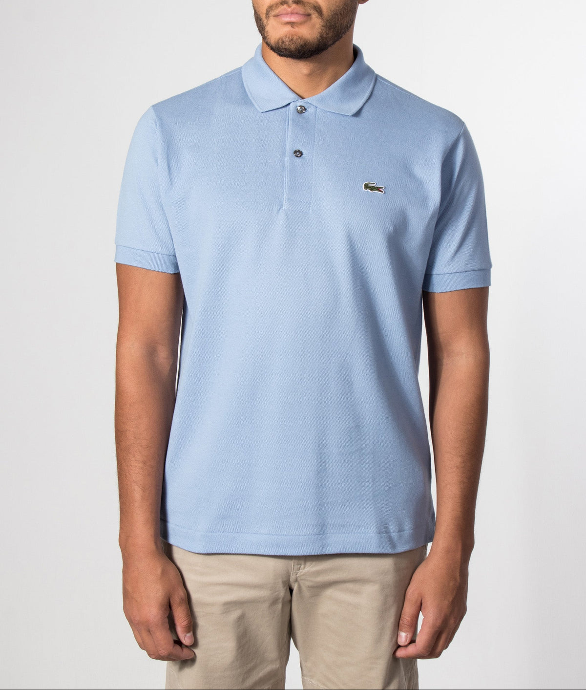 Lacoste Classic Fit L1212 Croc Logo Polo Shirt in Light Blue at EQVVS Menswear. Model front shot.