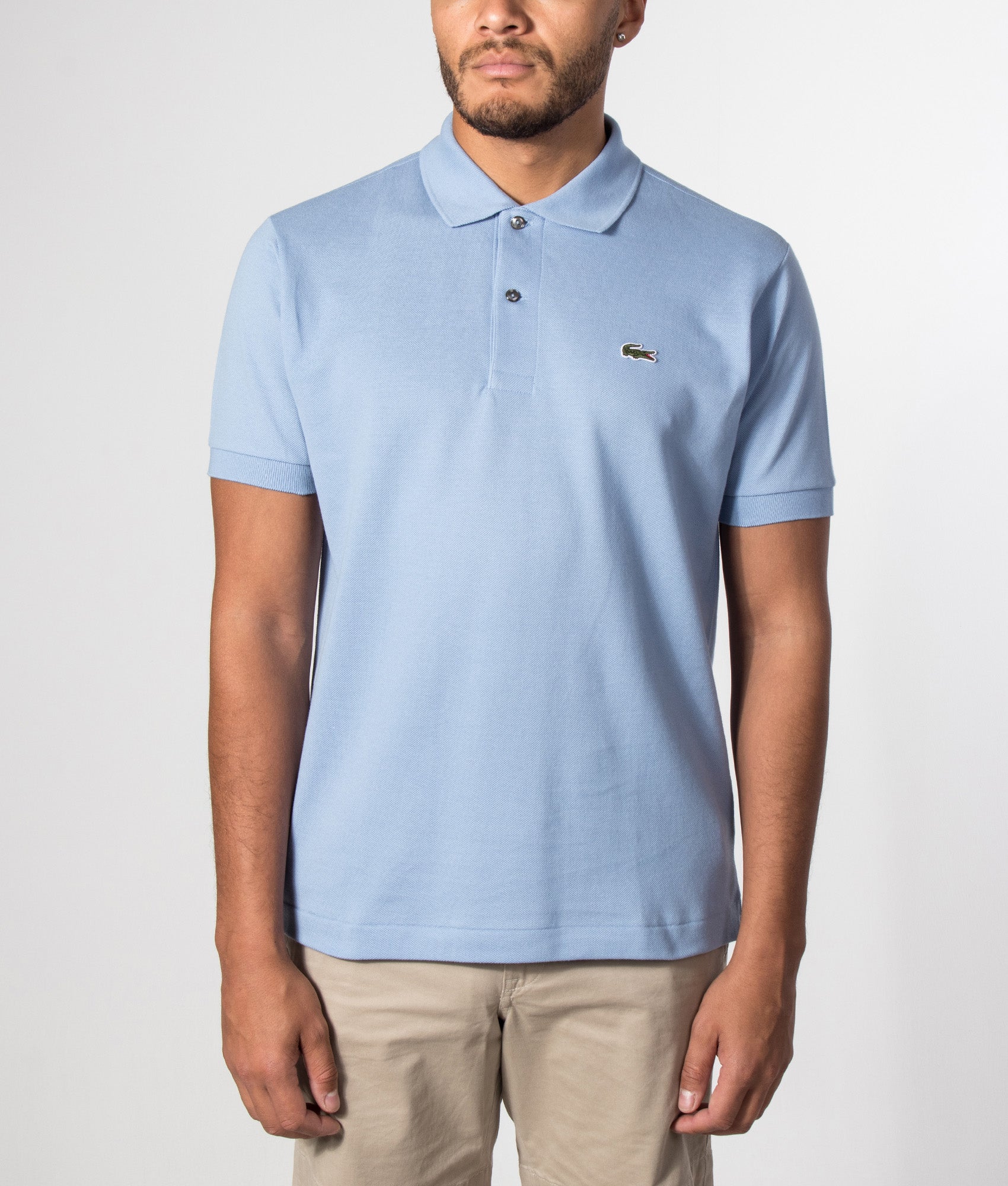 Lacoste Classic Fit L1212 Croc Logo Polo Shirt in Light Blue at EQVVS Menswear. Model front shot.
