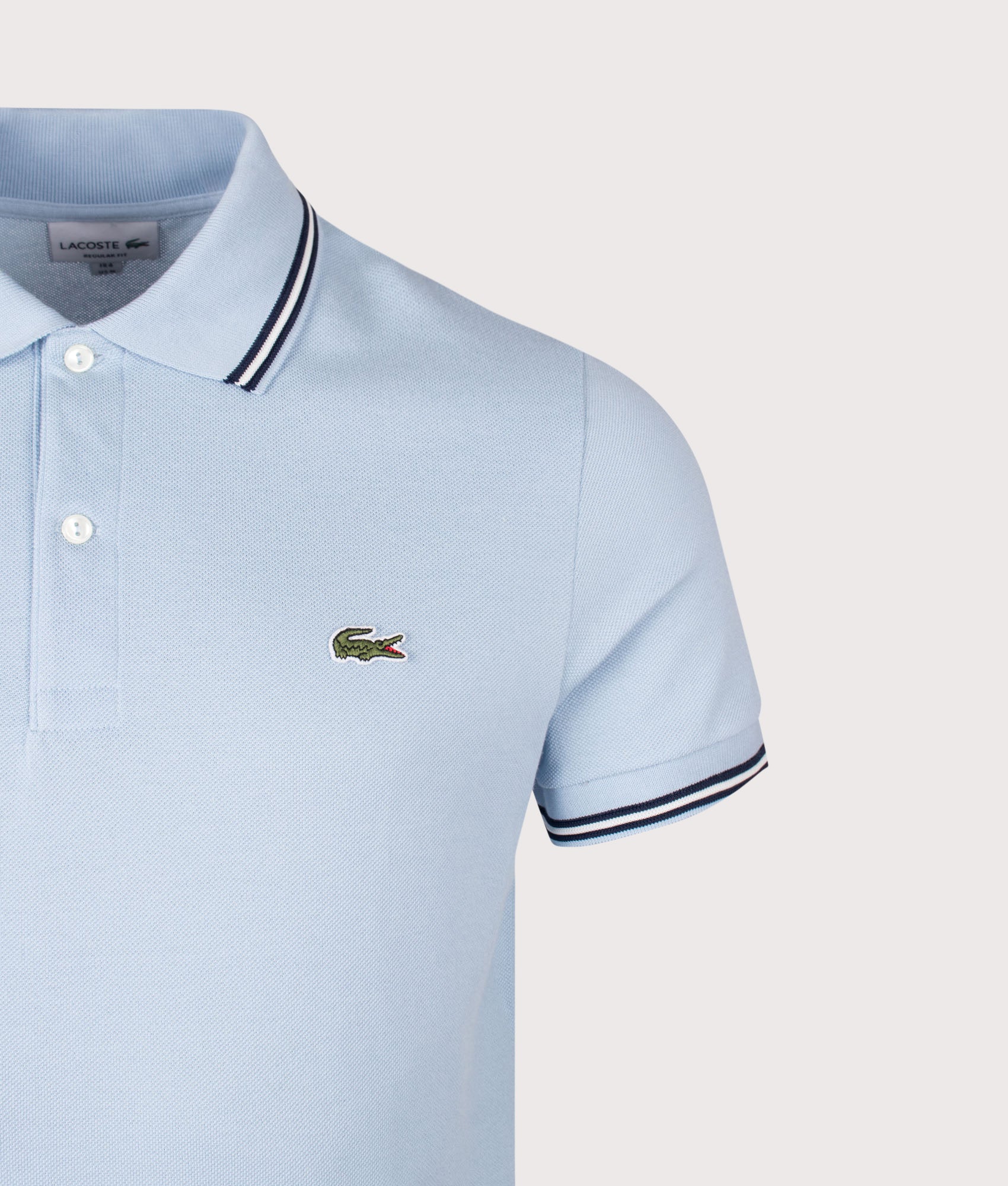 Lacoste Regular Fit Tipped Polo Shirt in Light Blue at EQVVS Menswear. Detail shot.