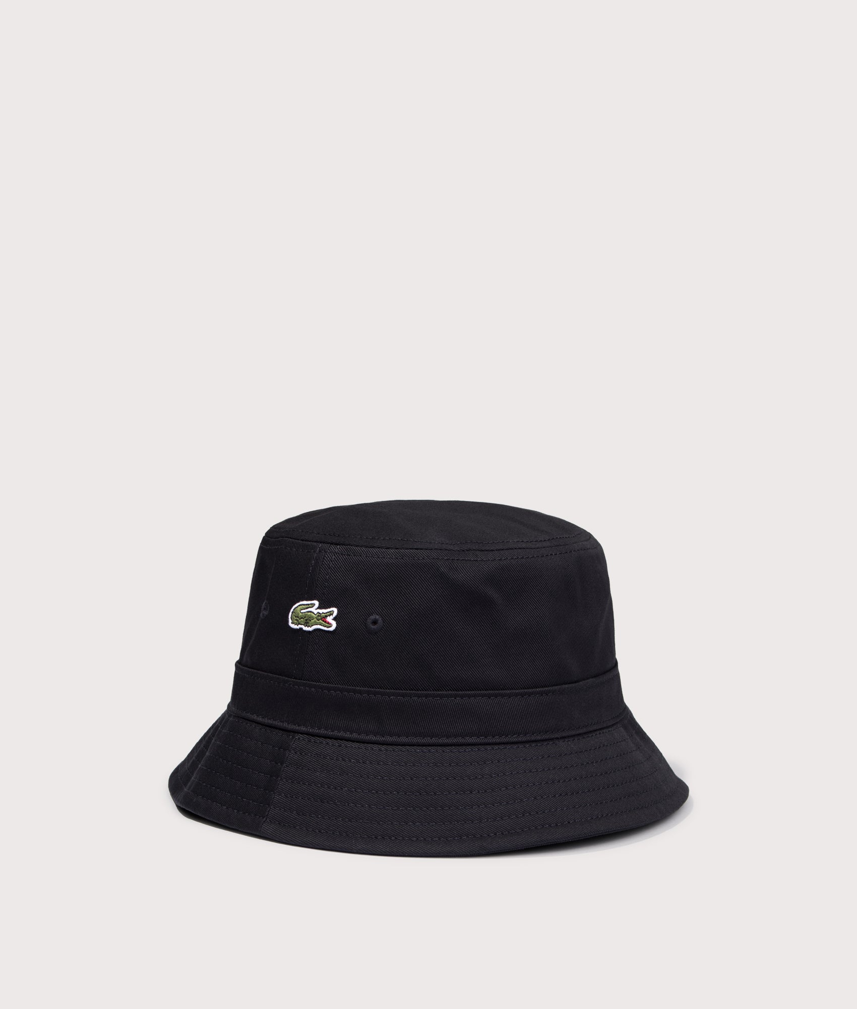 Piqué Bucket Hat in Black by Lacoste. Shot by EQVVS. Angled shot.