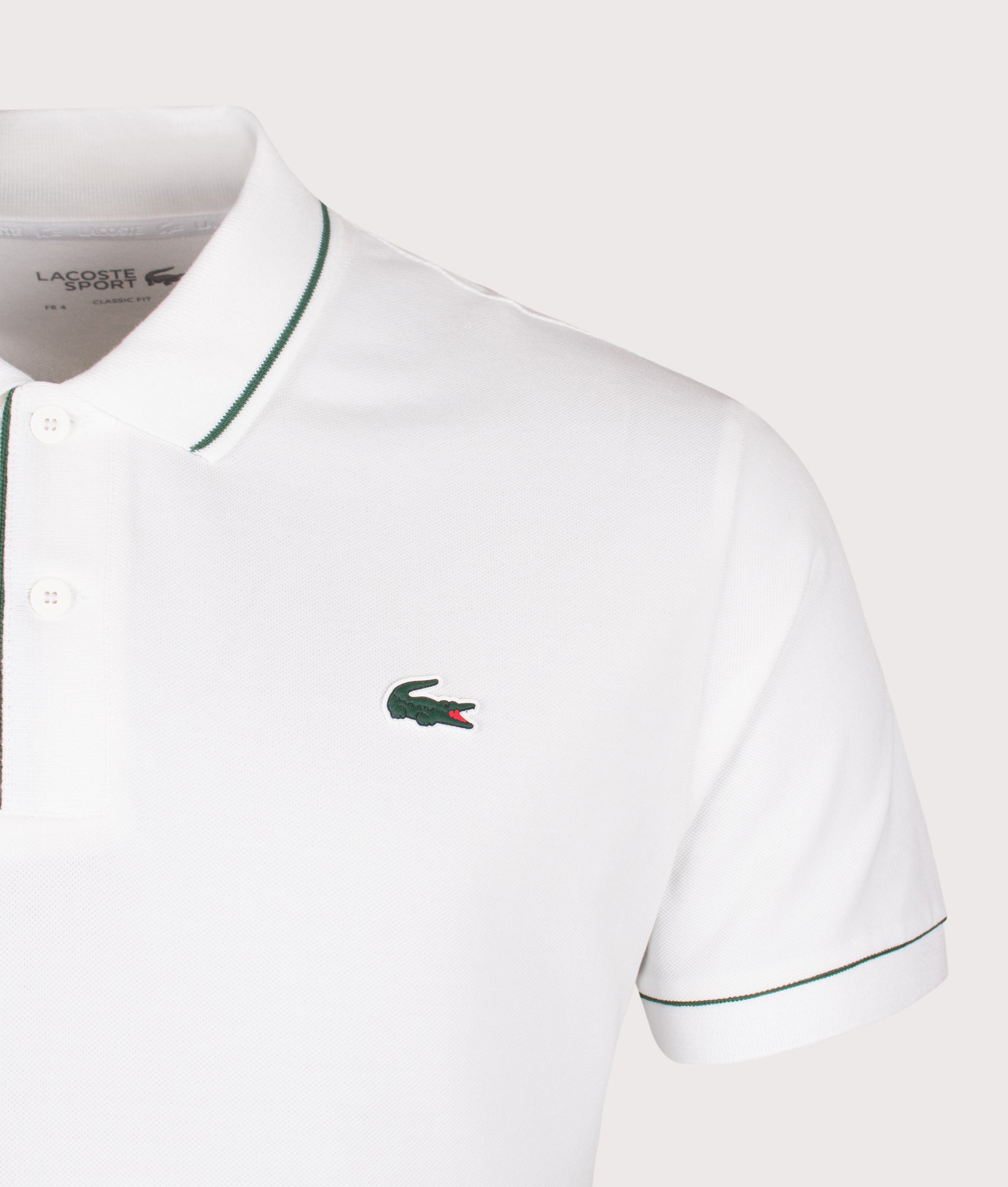 Lacoste Classic Fit Heat Regulating Mini Piqué Golf Polo Shirt in White at EQVVS Menswear. Detail shot.