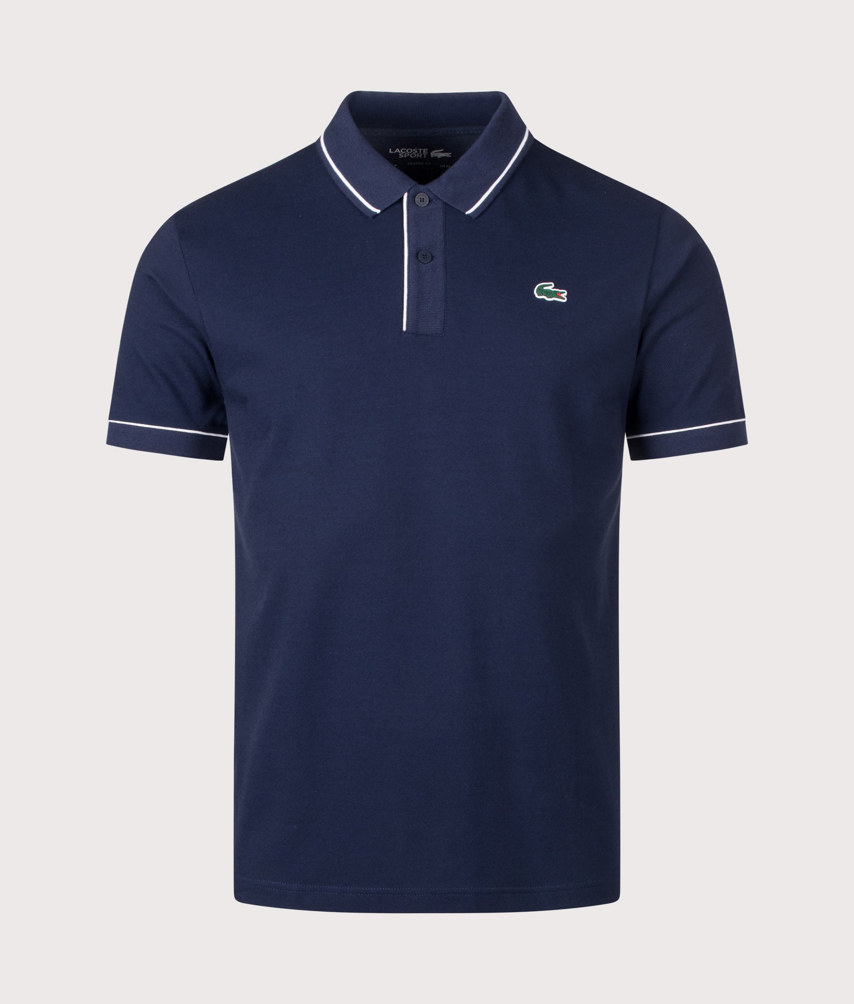 Lacoste Classic Fit Heat Regulating Mini Piqué Golf Polo Shirt in Midnight Blue at EQVVS Menswear. Front shot.