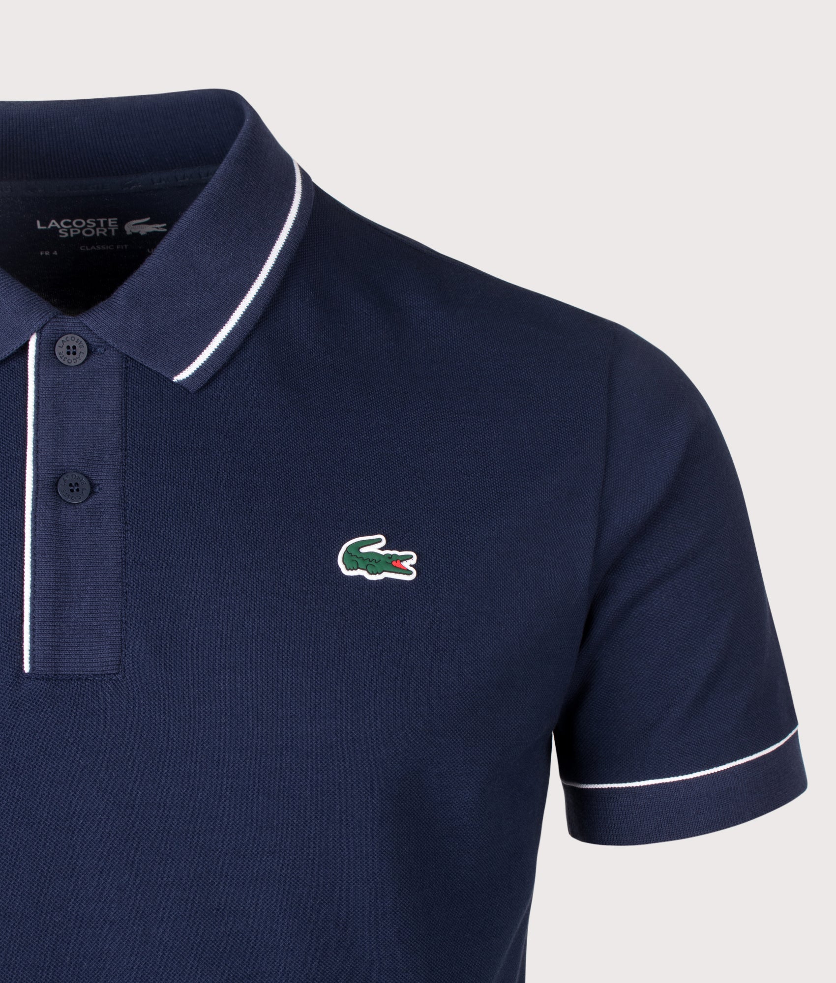 Lacoste Classic Fit Heat Regulating Mini Piqué Golf Polo Shirt in Midnight Blue at EQVVS Menswear. Detail shot.