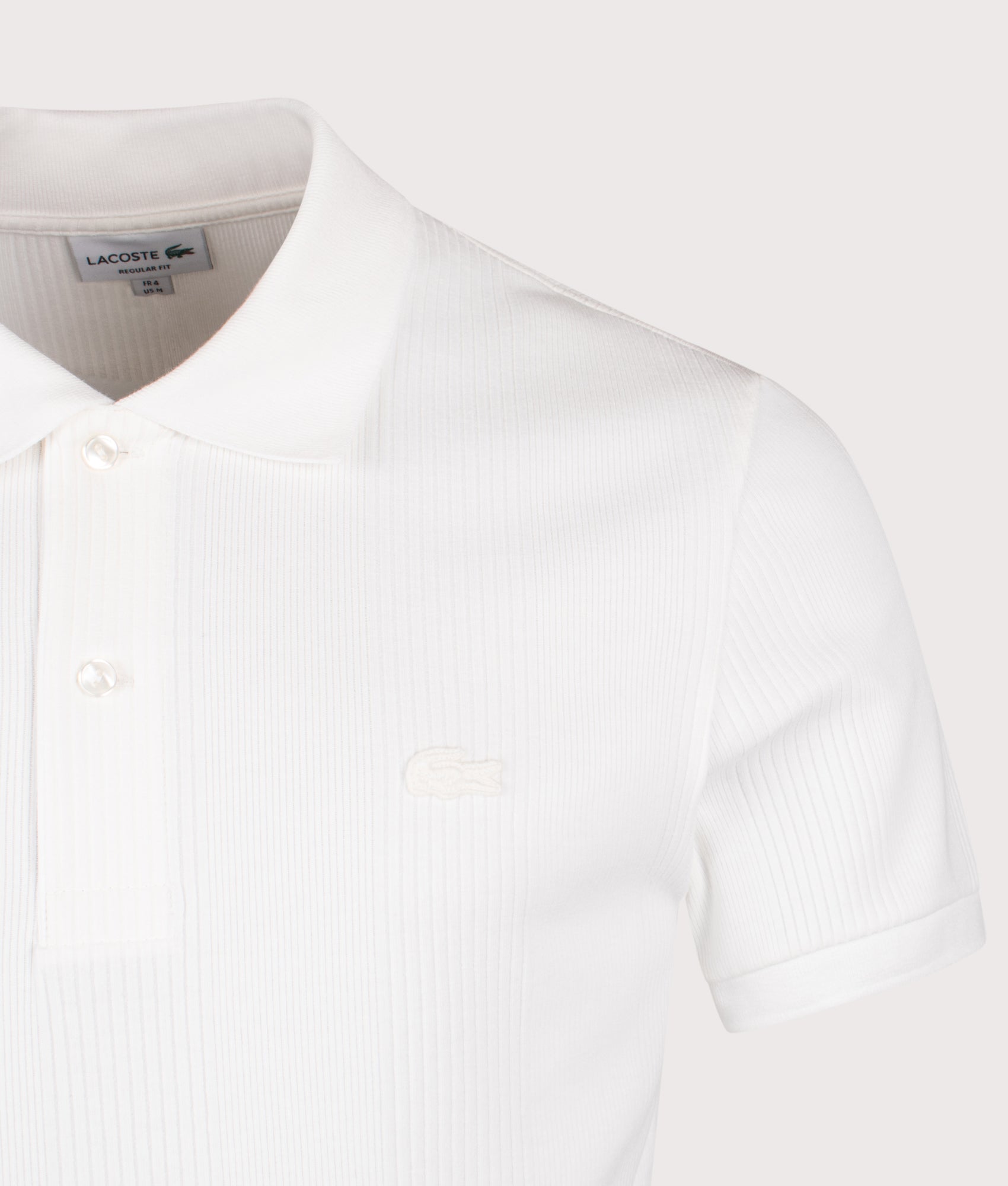Lacoste Ribbed Polo Shirt in Flour at EQVVS Menswear. Detail shot.