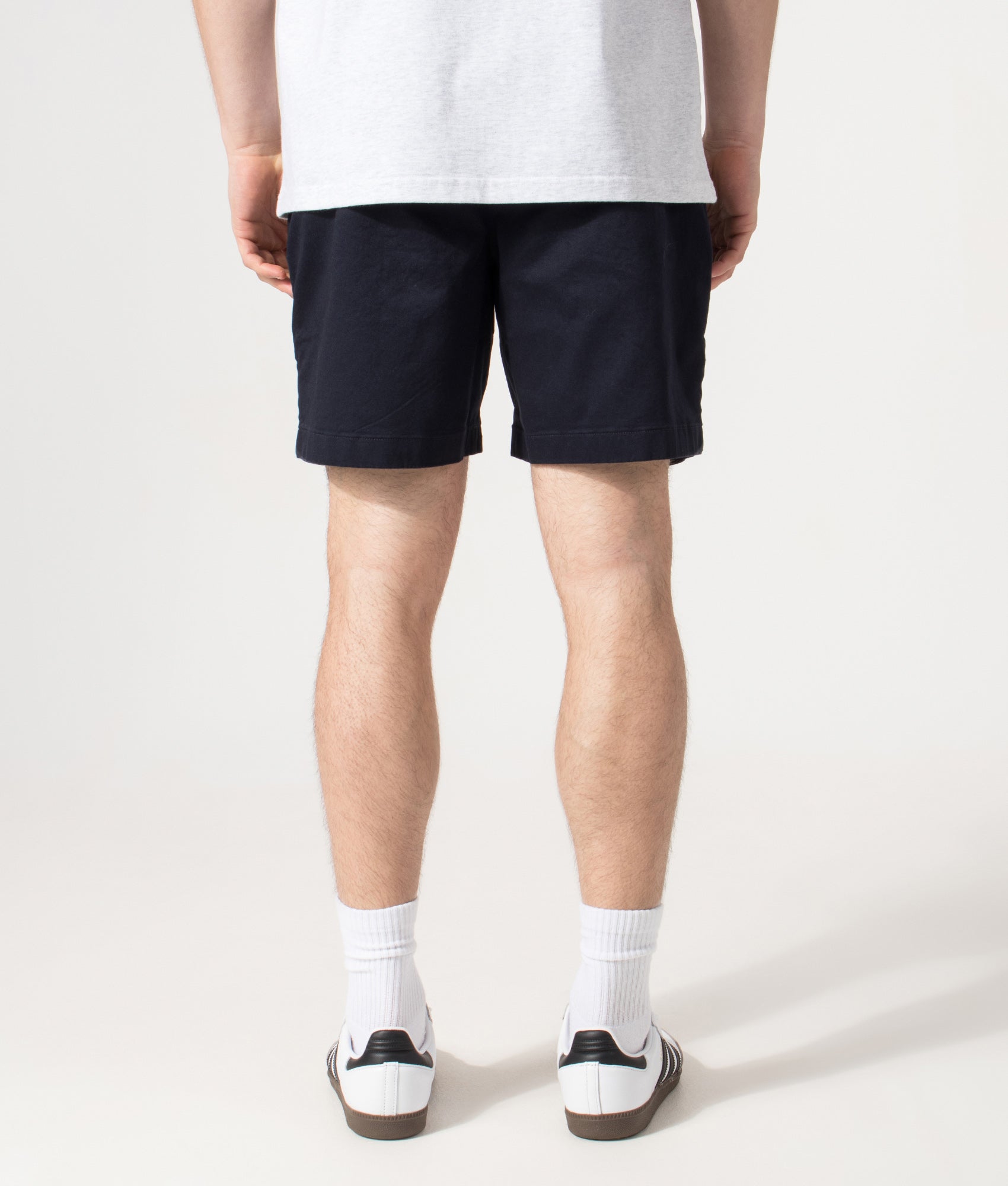Lacoste Regular Fit Stretch Cotton Chino Shorts in Abysm at EQVVS Menswear. Model back shot.