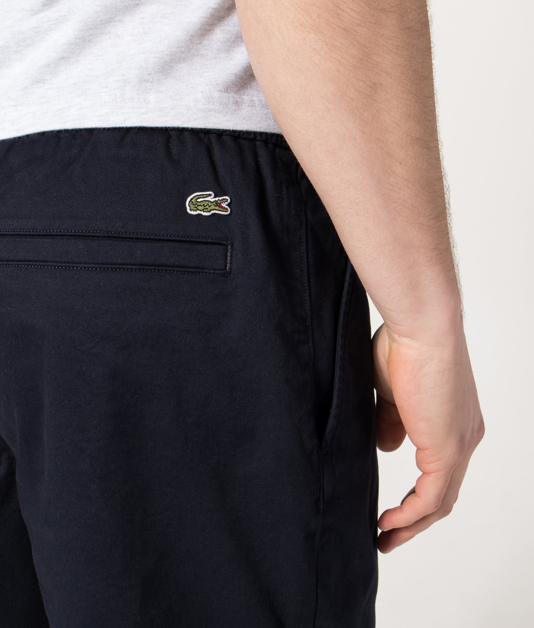 Lacoste Regular Fit Stretch Cotton Chino Shorts in Abysm at EQVVS Menswear. Detail shot.