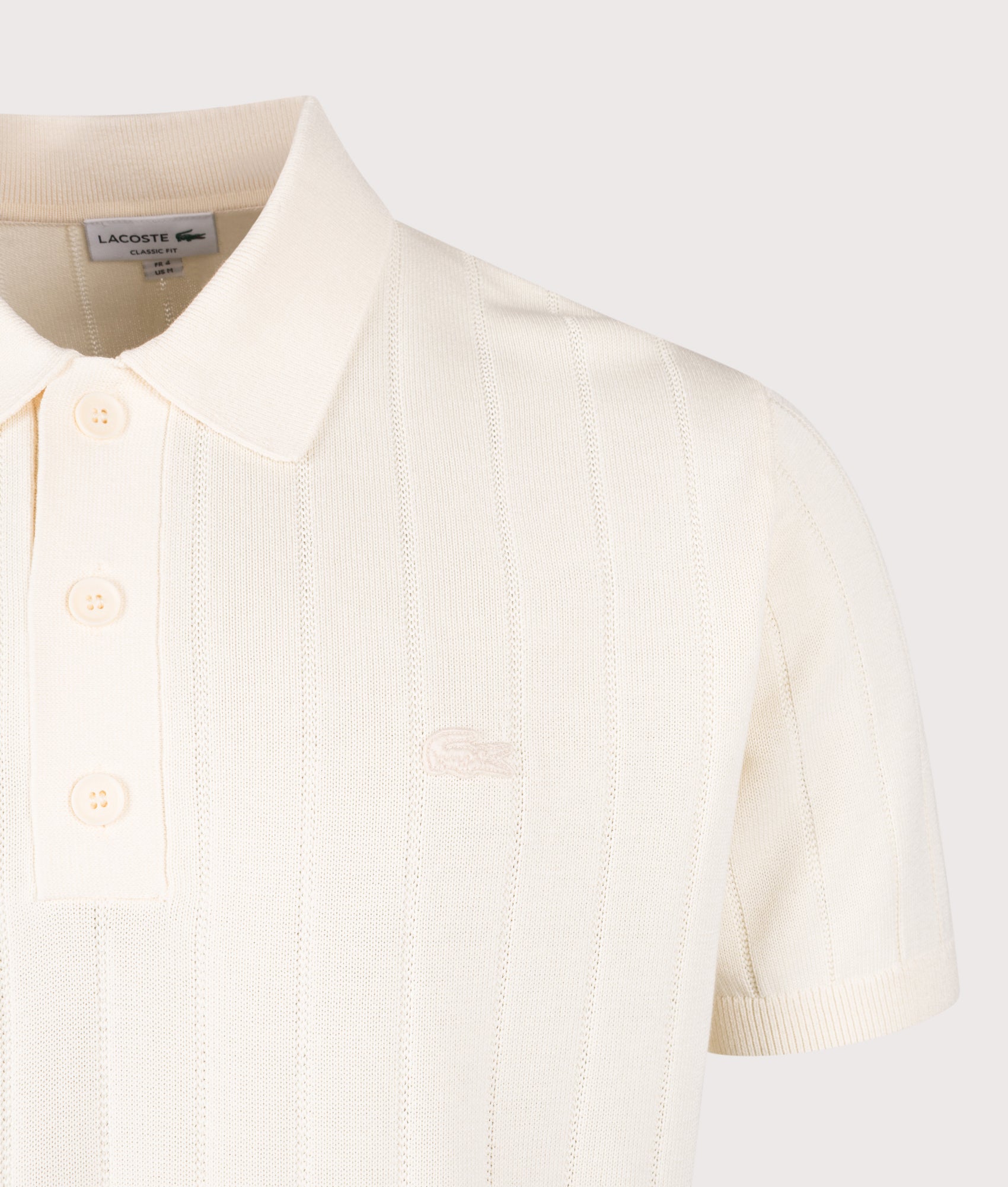 Lacoste Fluid Ribbed Knit Polo Shirt in Naturel Clair at EQVVS Menswear. Detail shot.