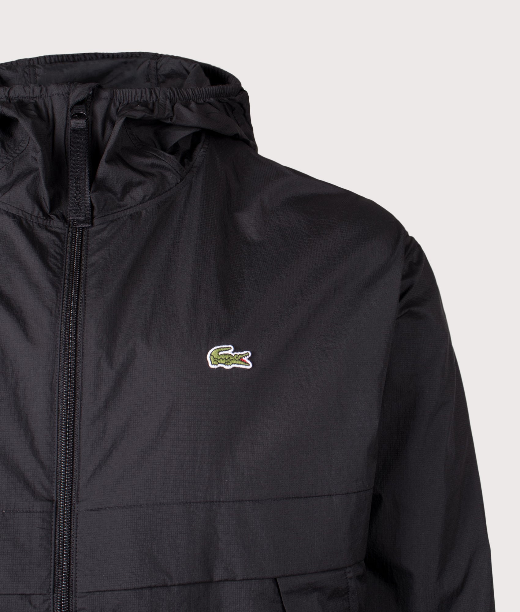 Lacoste Lightweight Packable Jacket in Black at EQVVS Menswear. Detail shot.