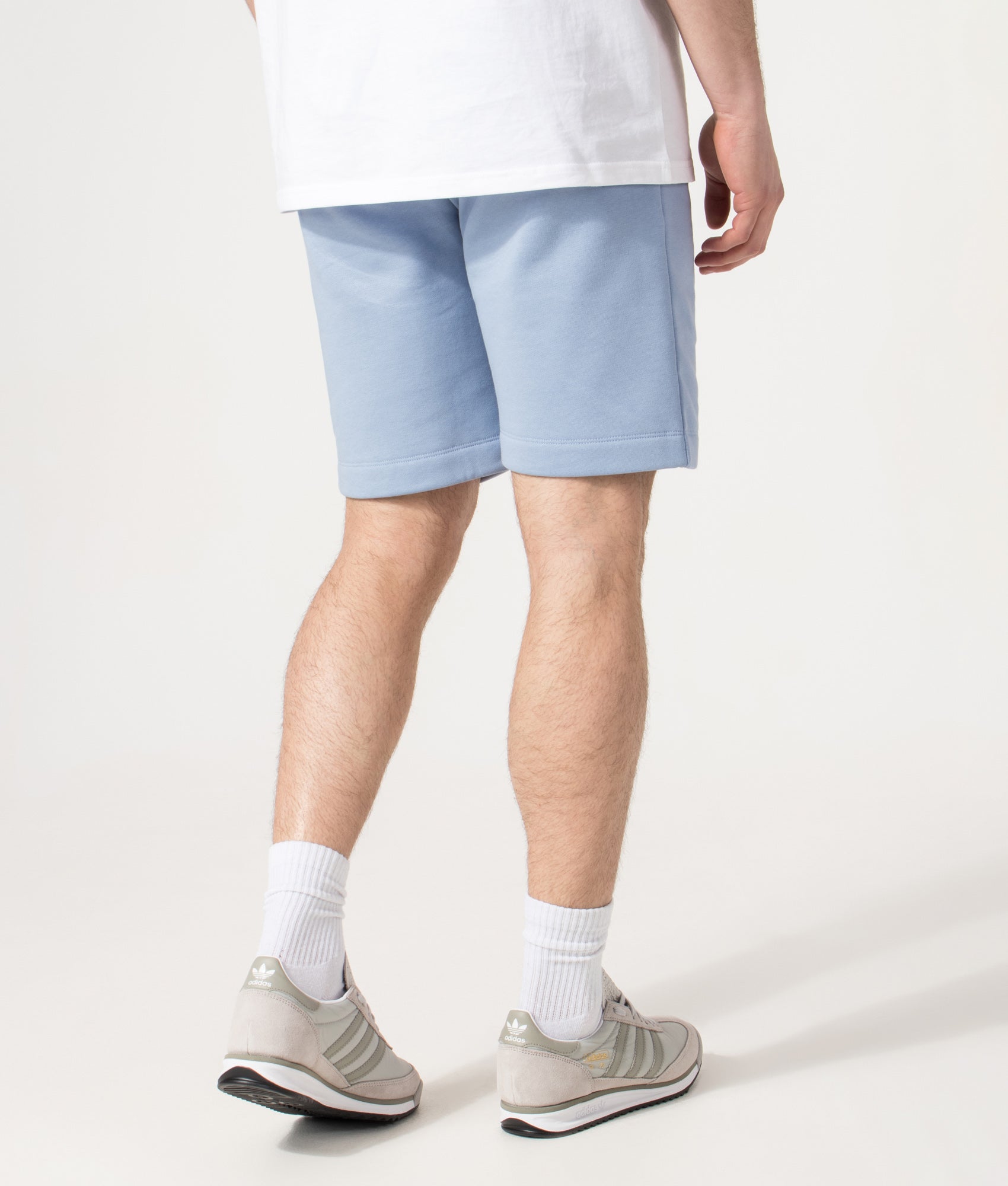 Lacoste Regular Fit Logo Sweat Shorts in Aphylla Blue at EQVVS Menswear. Model angled back shot.
