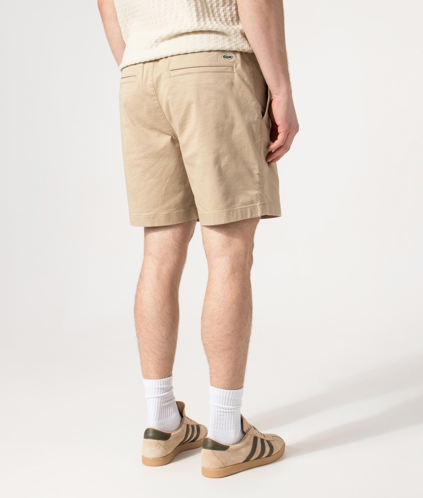 Lacoste Regular Fit Stretch Cotton Chino Shorts in Viennese Beige at EQVVS Menswear. Angled model back shot.