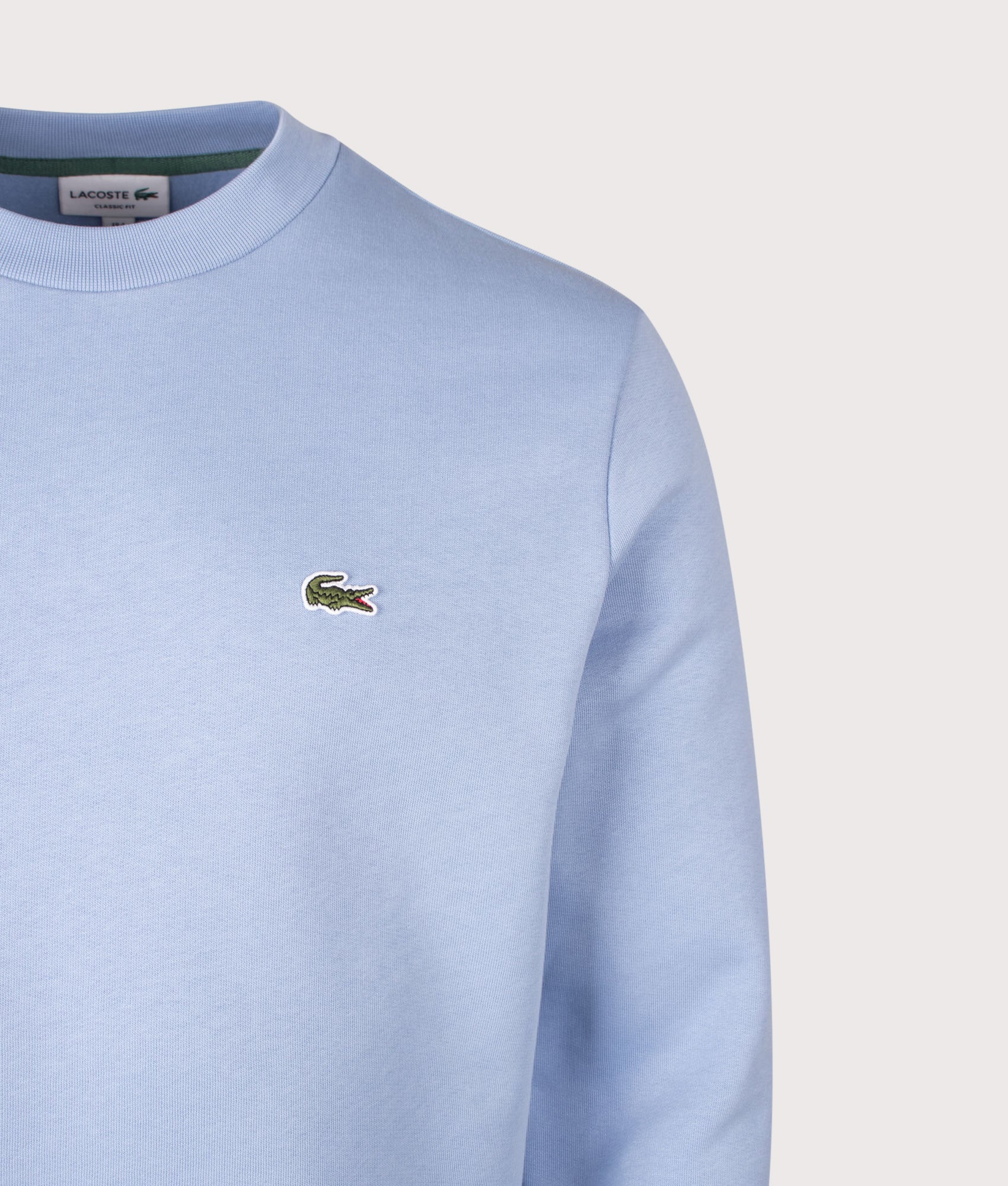 Lacoste Relaxed Fit Brushed Cotton Sweatshirt in Light Blue at EQVVS Menswear. Detail shot.