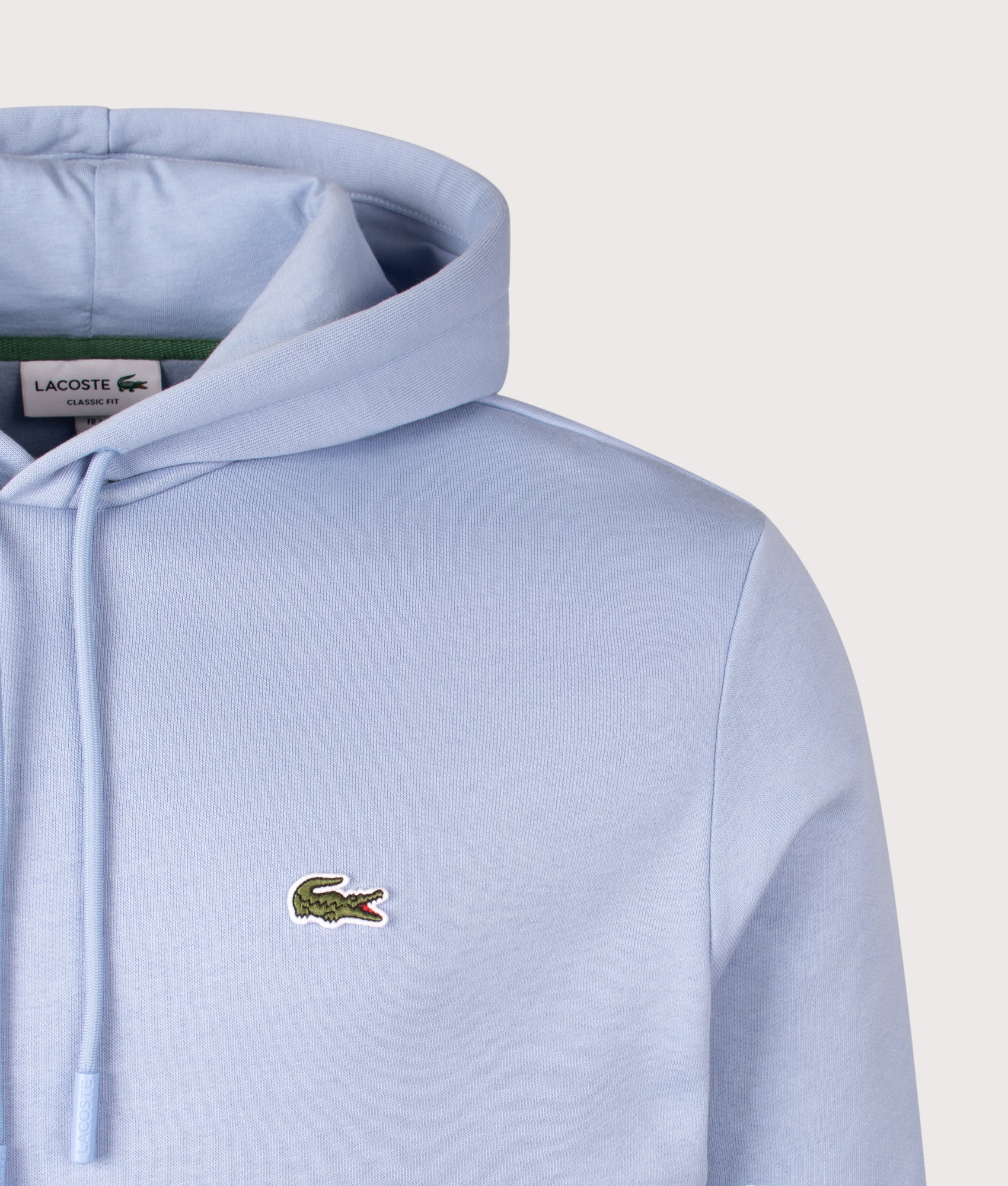 Lacoste Relaxed Fit Brushed Fleece Hoodie in Aphylla at EQVVS Menswear. Detail shot.