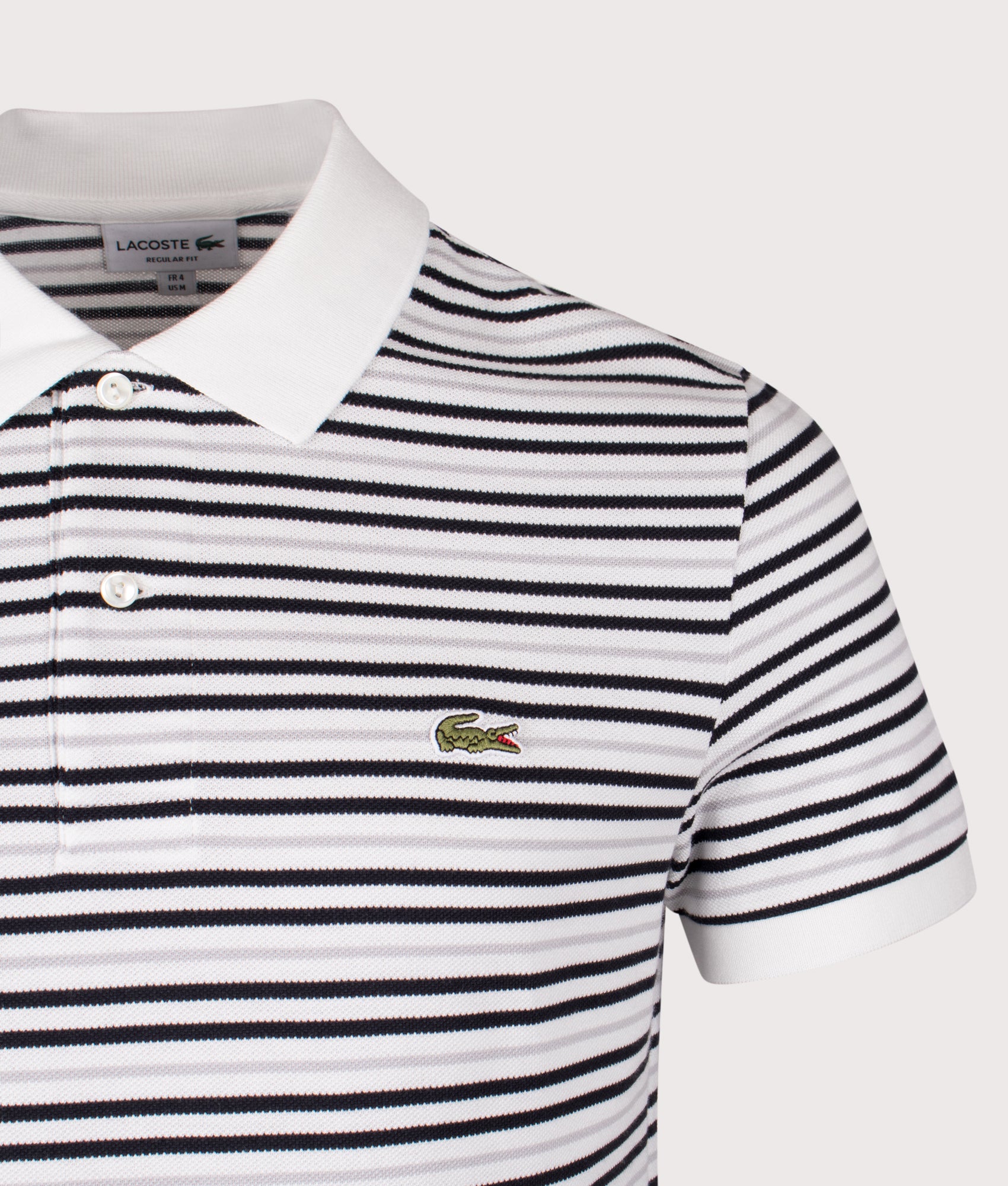 Lacoste Striped Petit Piqué Polo Shirt in Blackbird and Flour at EQVVS Menswear. Detail shot.
