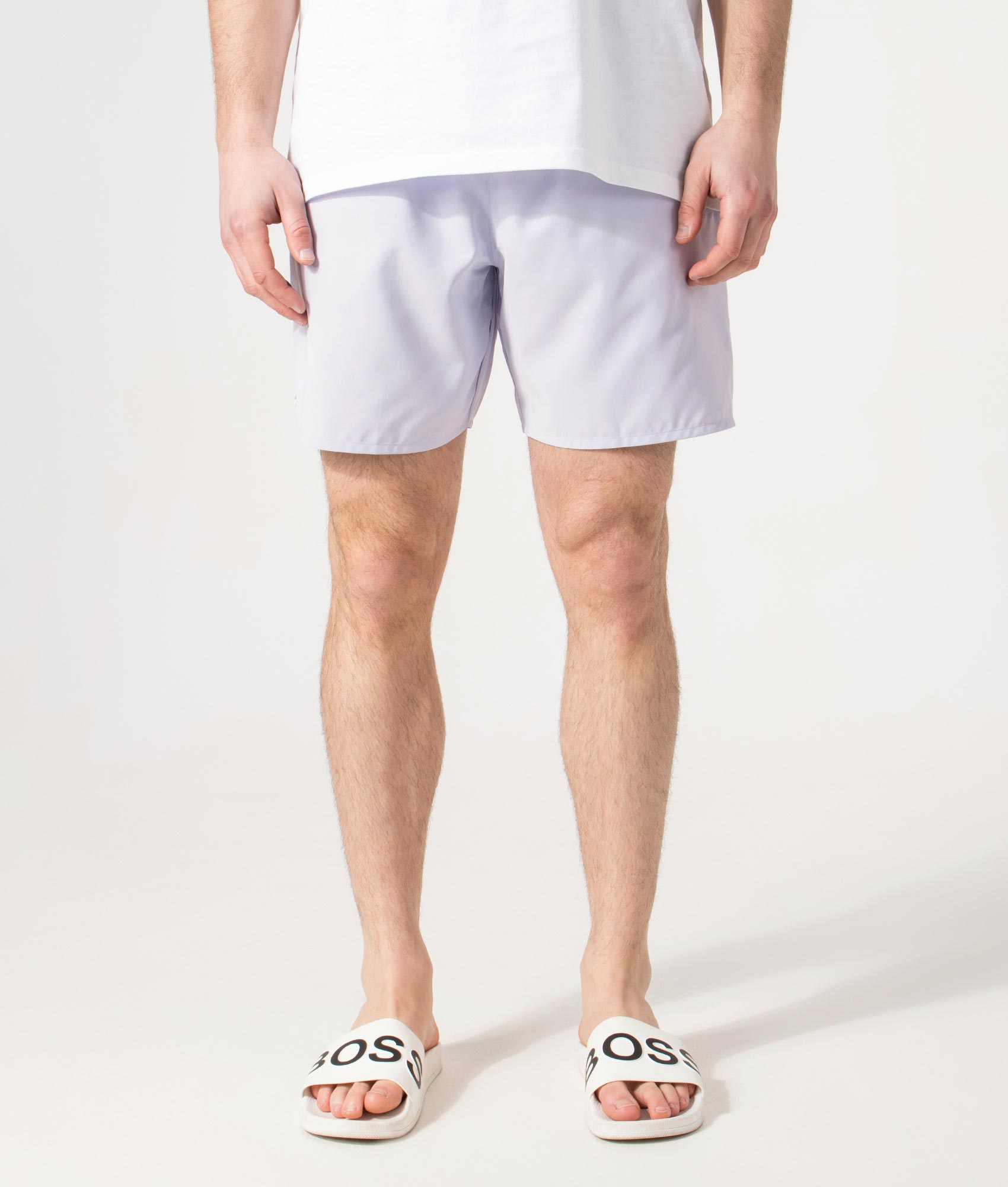 Lacoste Swim shorts in Phoenix Blue and Green at EQVVS Menswear. Model front shot.
