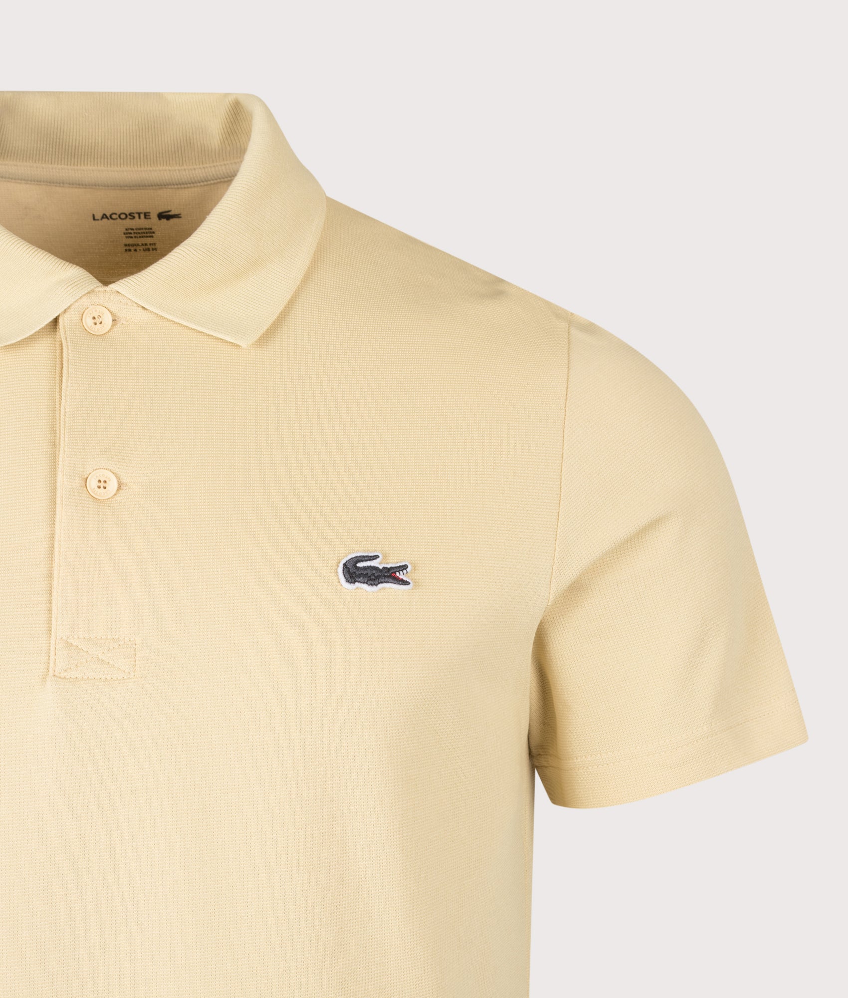 Lacoste Regular Fit Cotton Blend Polo Shirt in Beige at EQVVS Menswear. Detail shot.