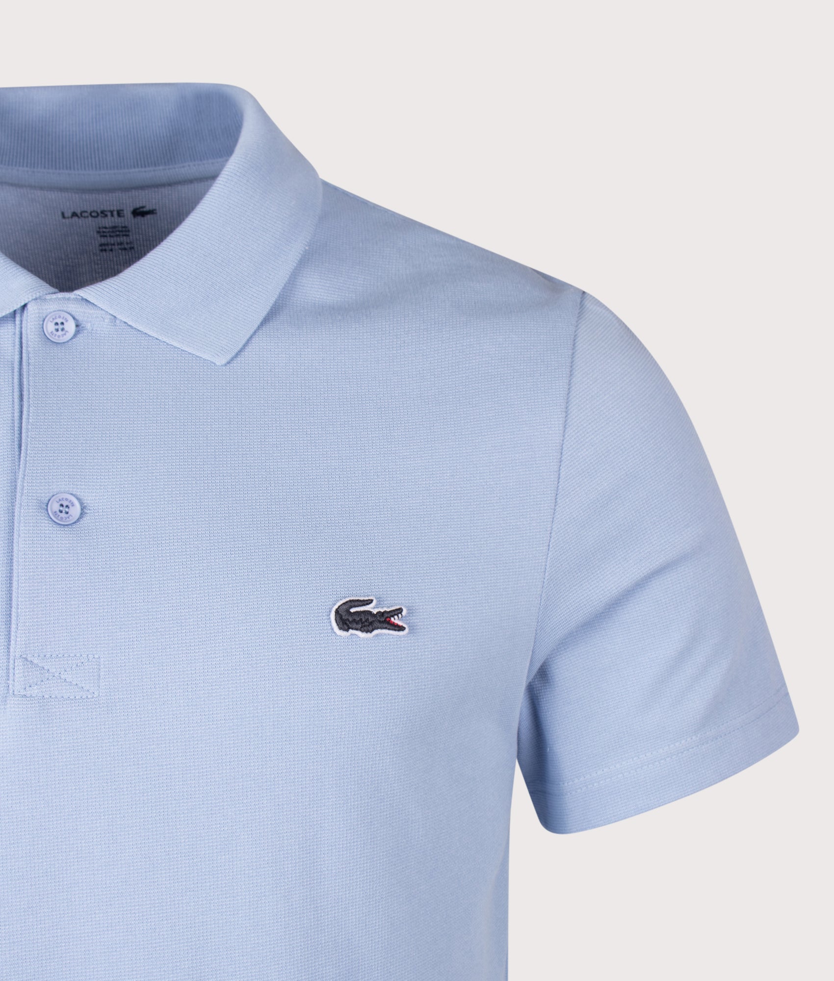 Lacoste Regular Fit Cotton Blend Polo Shirt in Light Blue at EQVVS Menswear. Detail shot.