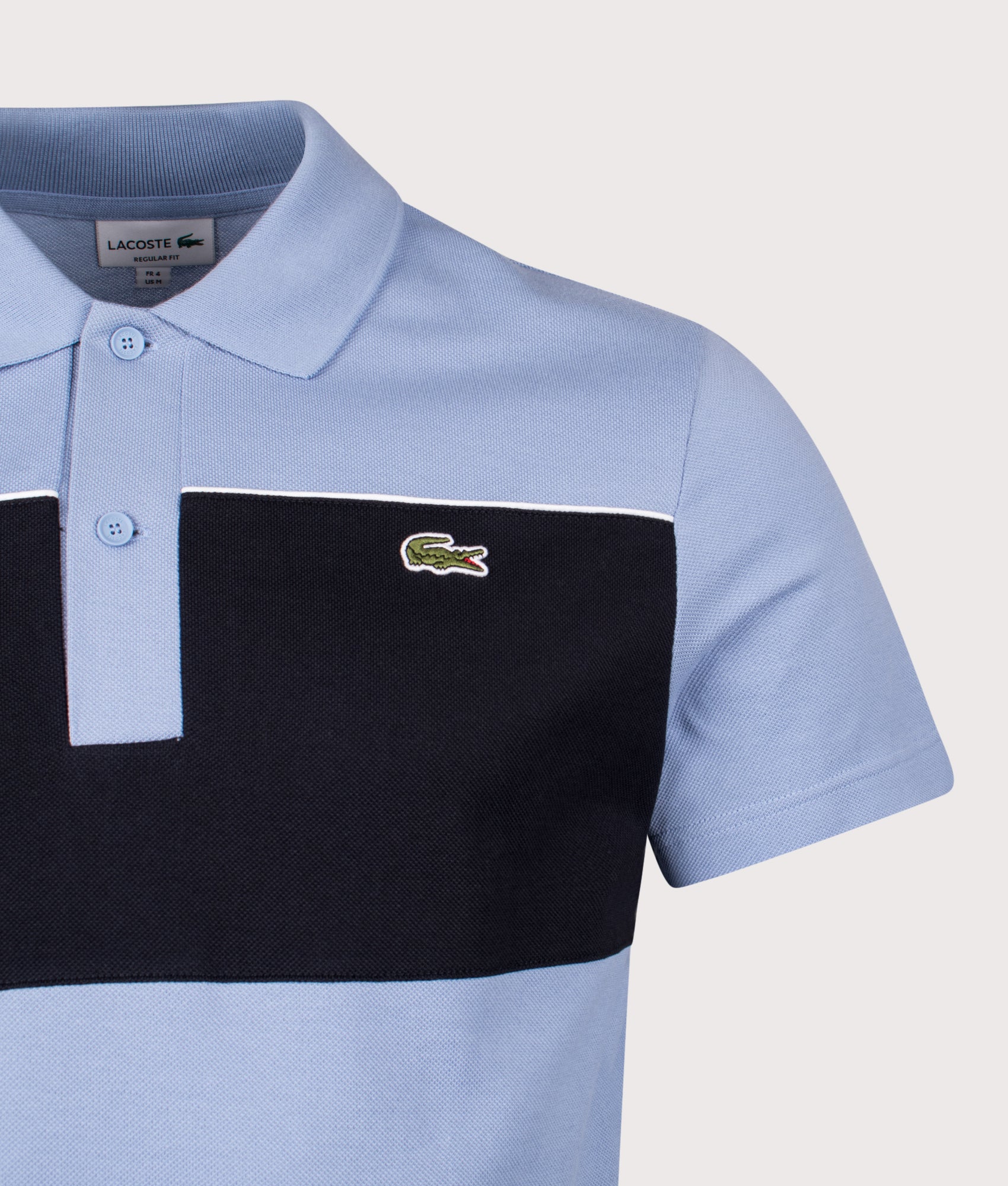 Lacoste Colour Block Piqué Polo Shirt in Aphylla and Blackbird at EQVVS Menswear. Detail shot.