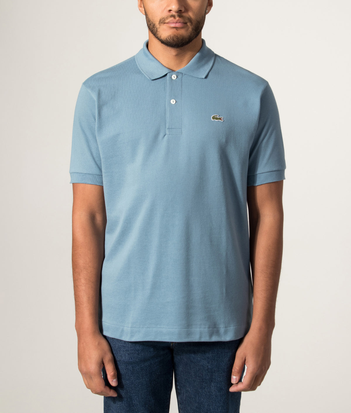 Lacoste Classic Fit L1212 Croc Logo Polo Shirt in Blue at EQVVS Menswear. Model front shot.