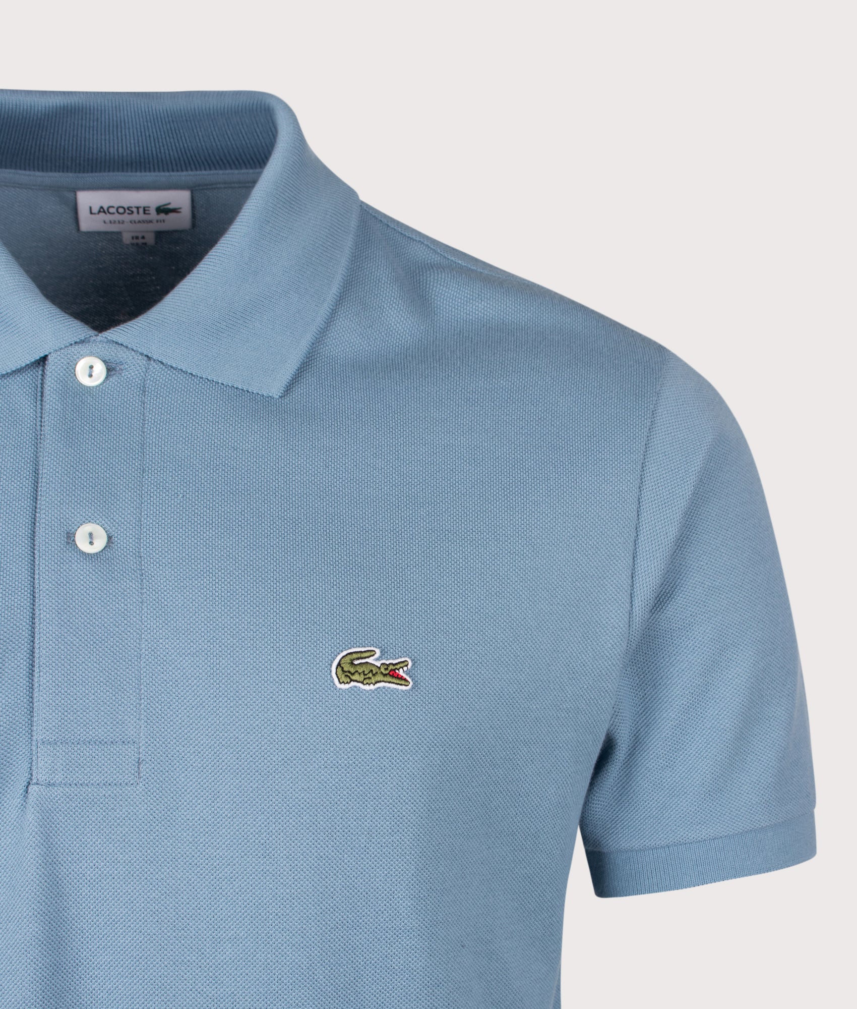 Lacoste Classic Fit L1212 Croc Logo Polo Shirt in Blue at EQVVS Menswear. Detail shot.