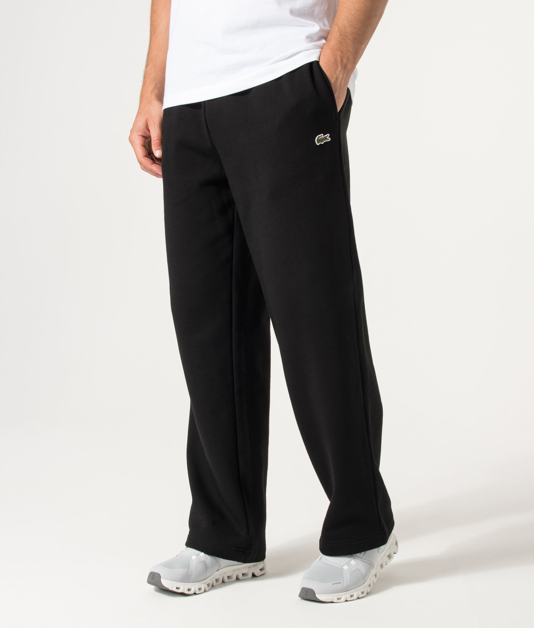 Lacoste Relaxed Fit Tracksuit Pants in Black at EQVVS Menswear. Model front shot.