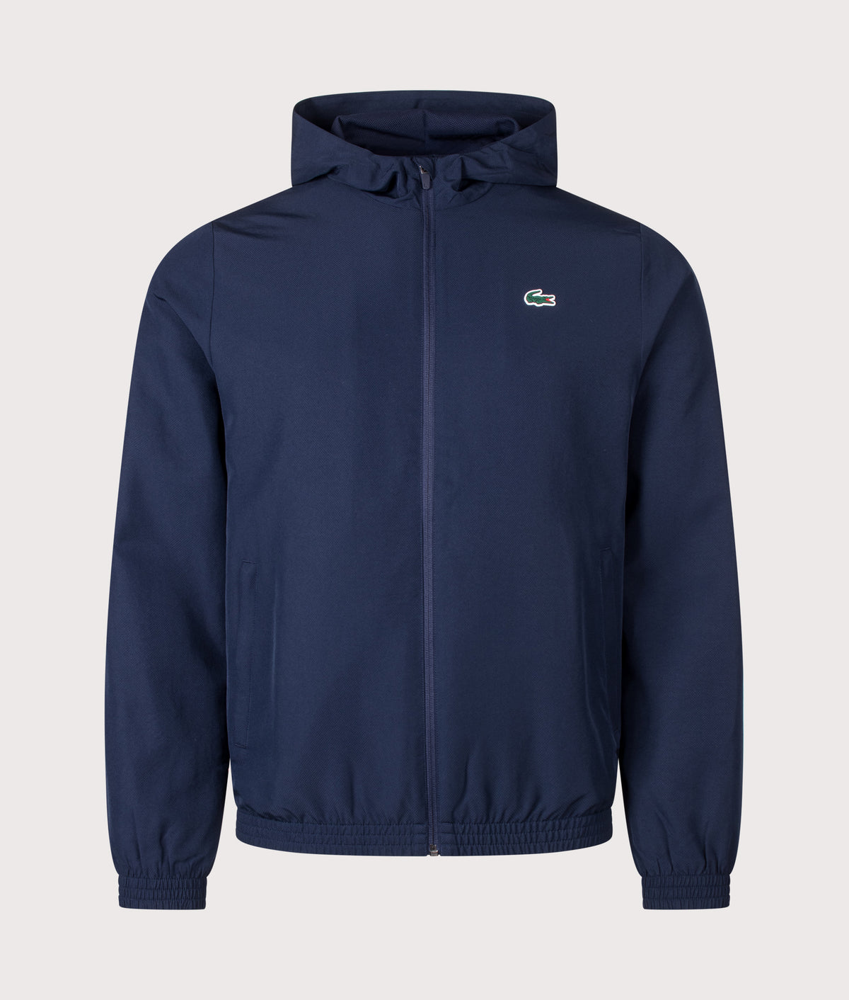 Lacoste Regular Fit Water-Repellent Sport Track Jacket in Navy Blue at EQVVS Menswear. Front shot.