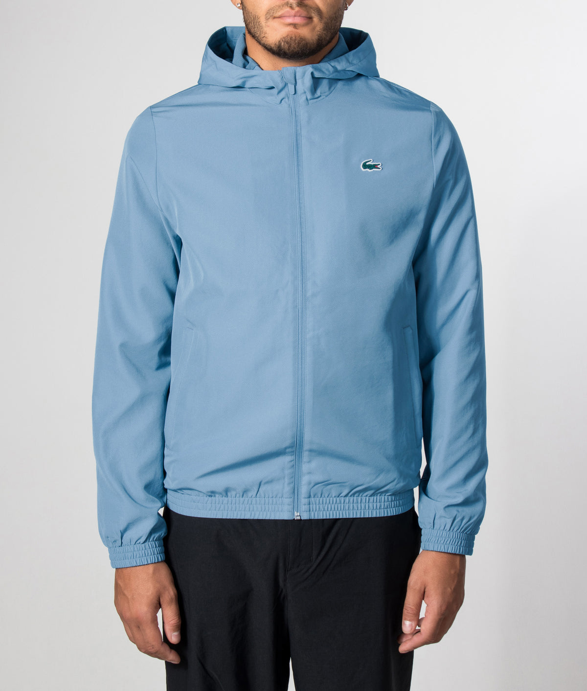 Lacoste Regular Fit Water-Repellent Sport Track Jacket in Aral at EQVVS Menswear. Model front shot.