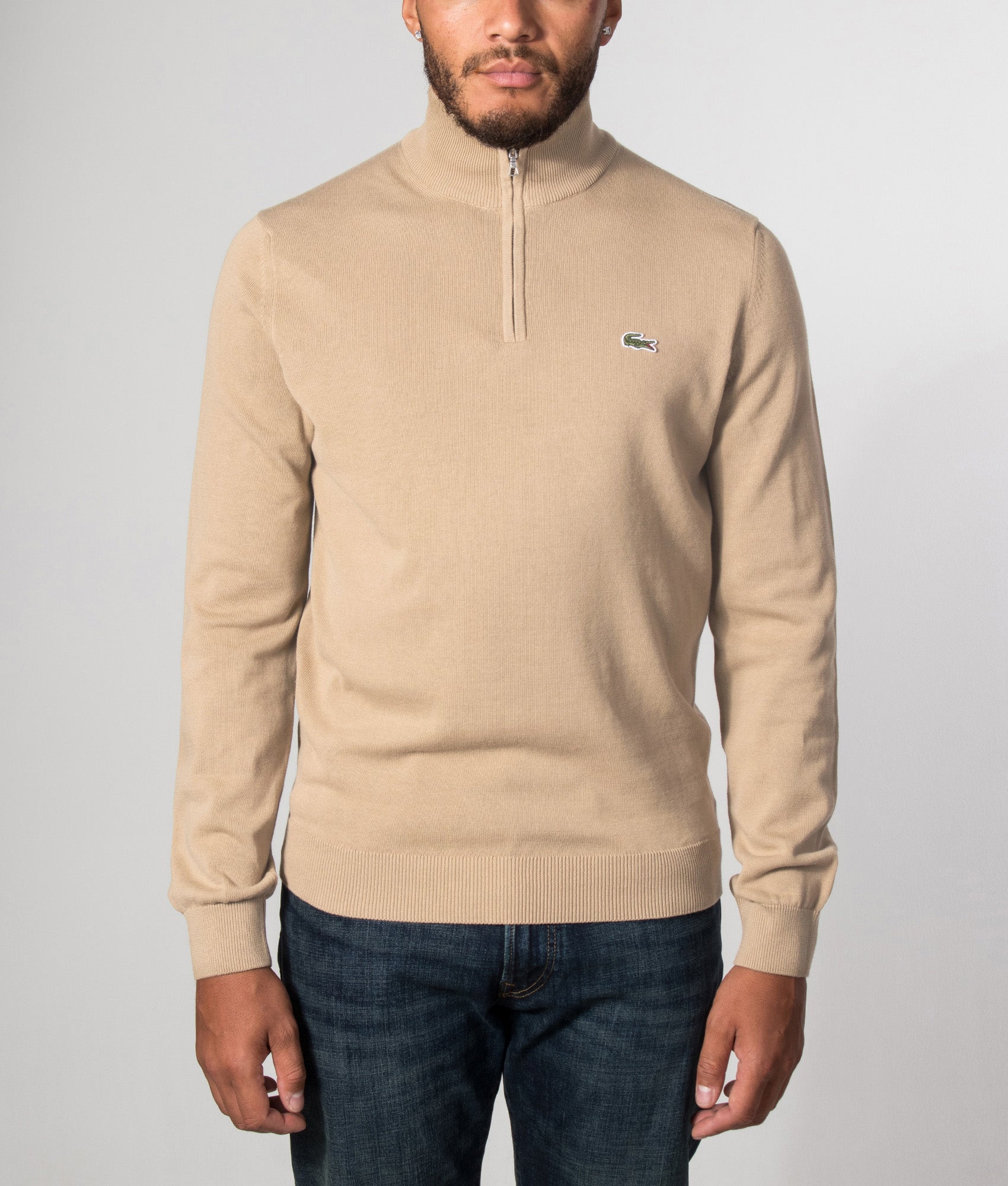 Lacoste Regular Fit Quarter Zip Knit Jumper in Cookie at EQVVS Menswear. Model front shot.