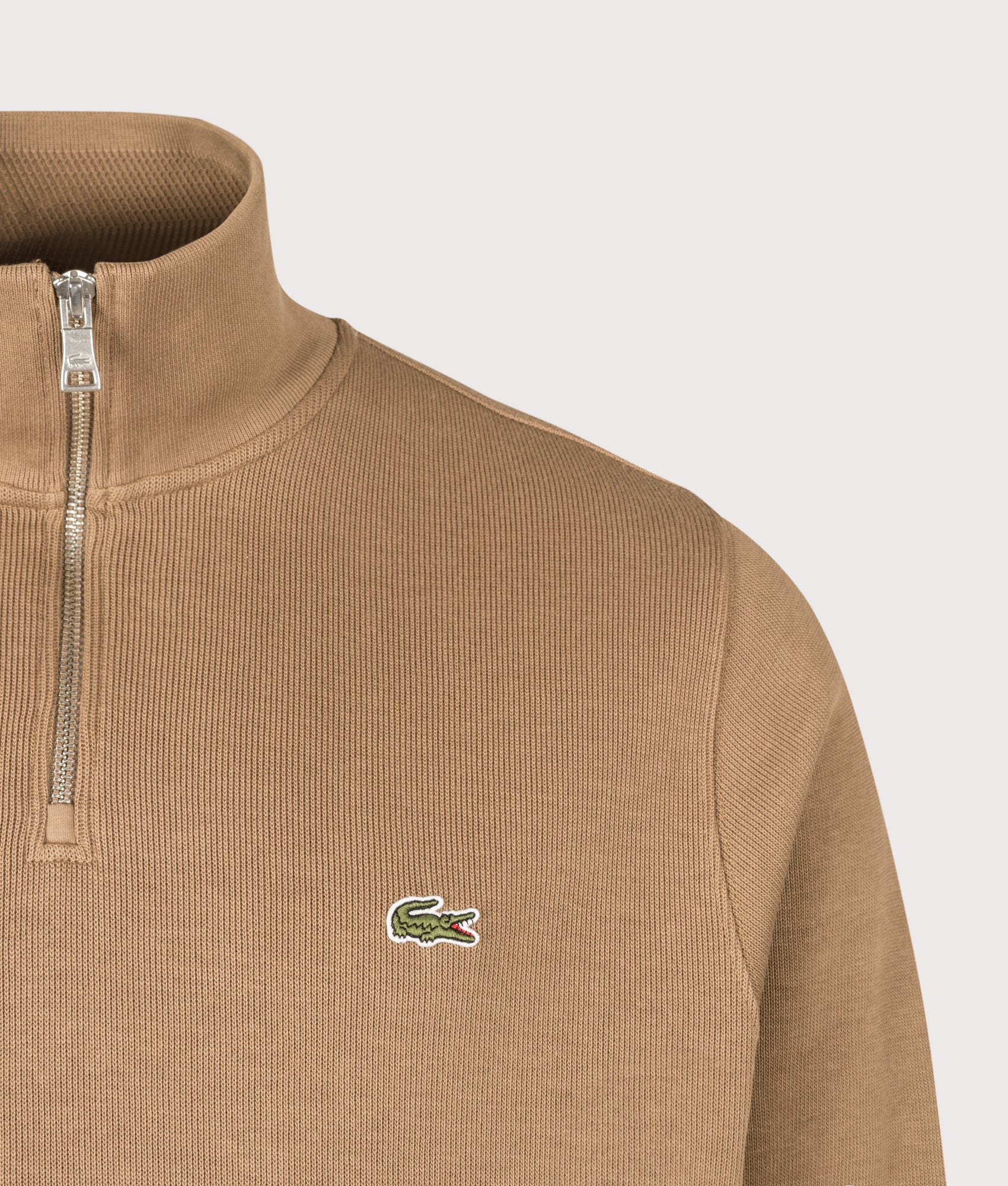 Lacoste Regular Fit Croc Logo Quarter Zip Knit Jumper in Cookie at EQVVS Menswear. Detail shot.