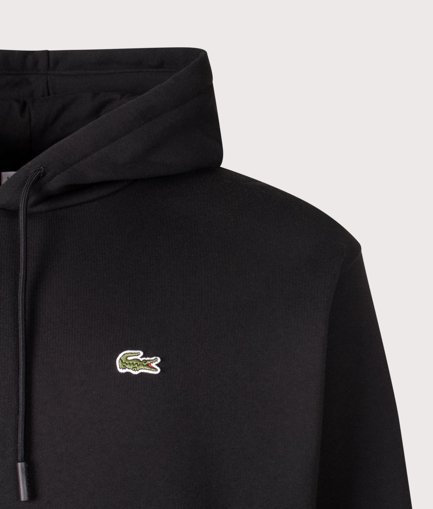 Lacoste Classic Fit Hoodie in Black at EQVVS Menswear. Detail shot.