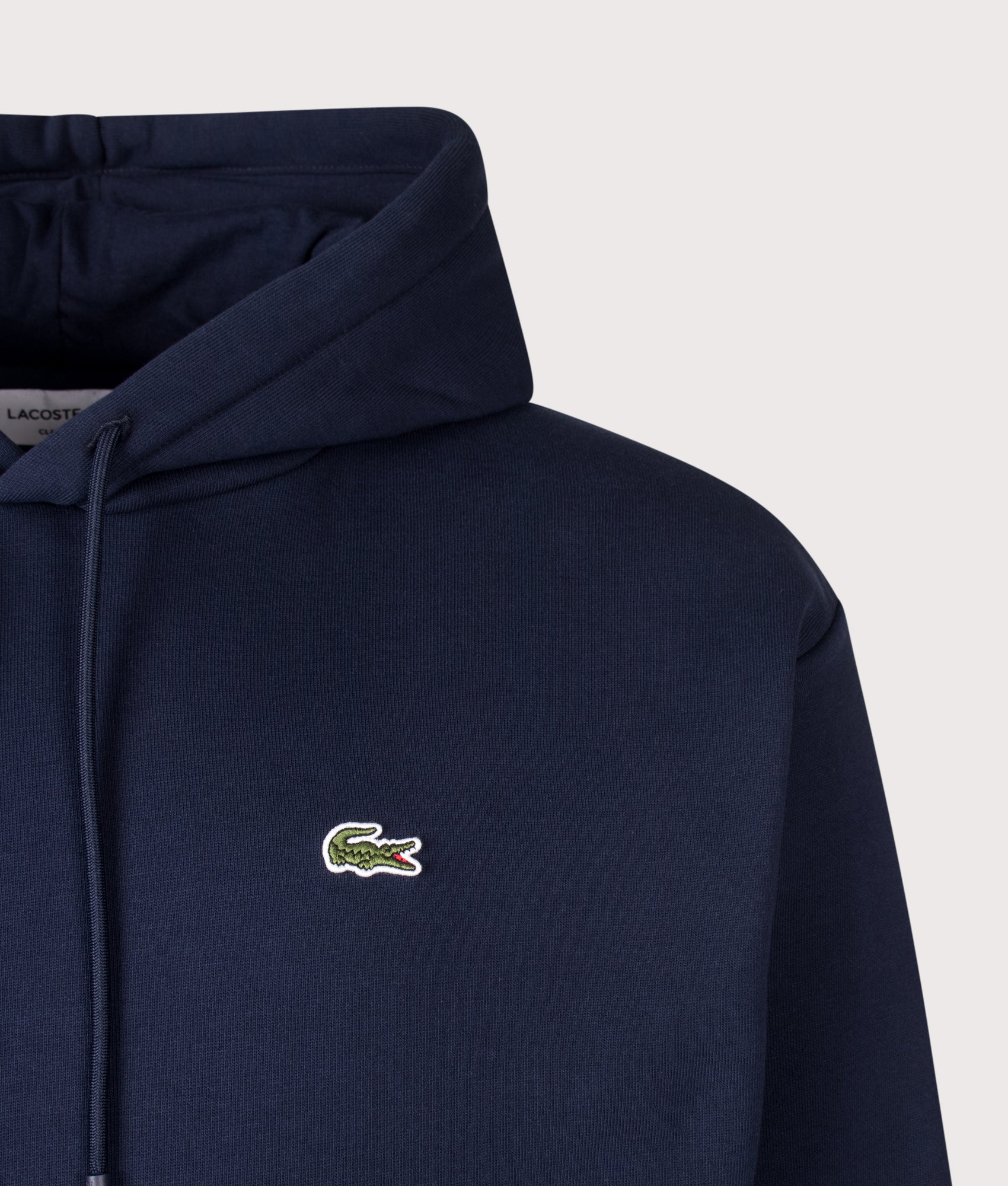 Lacoste Classic Fit Hoodie in Navy Blue at EQVVS Menswear. Detail shot.