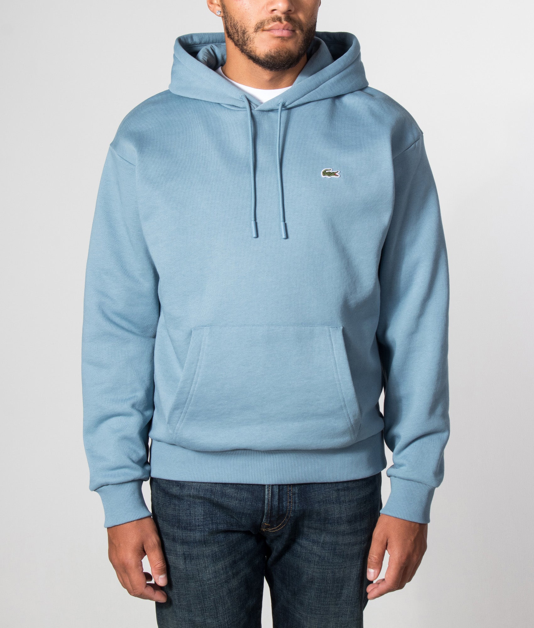 Lacoste Classic Fit Fleece Hoodie in Aral at EQVVS Menswear. Model front shot.
