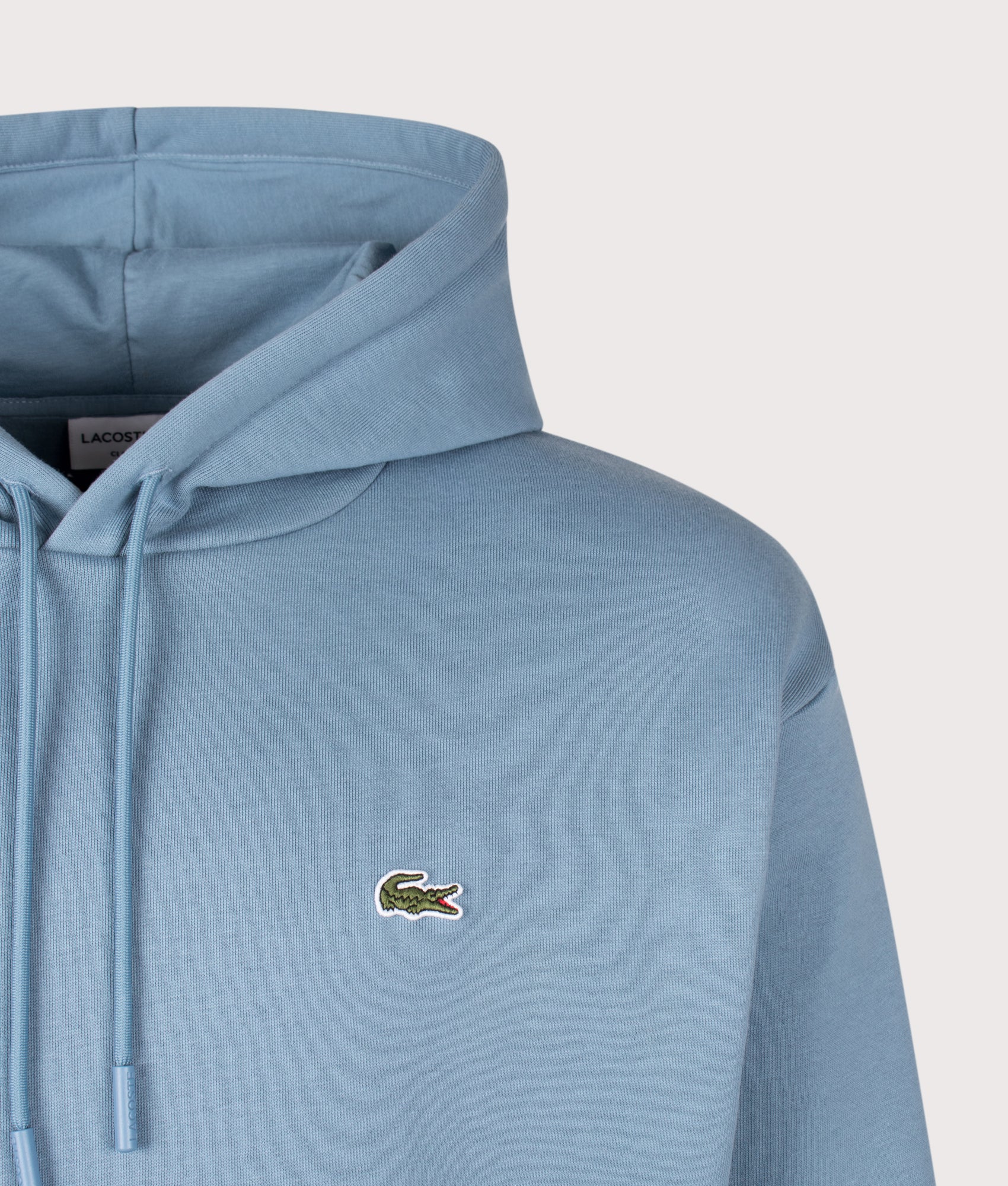 Lacoste Classic Fit Fleece Hoodie in Aral at EQVVS Menswear. Detail shot.