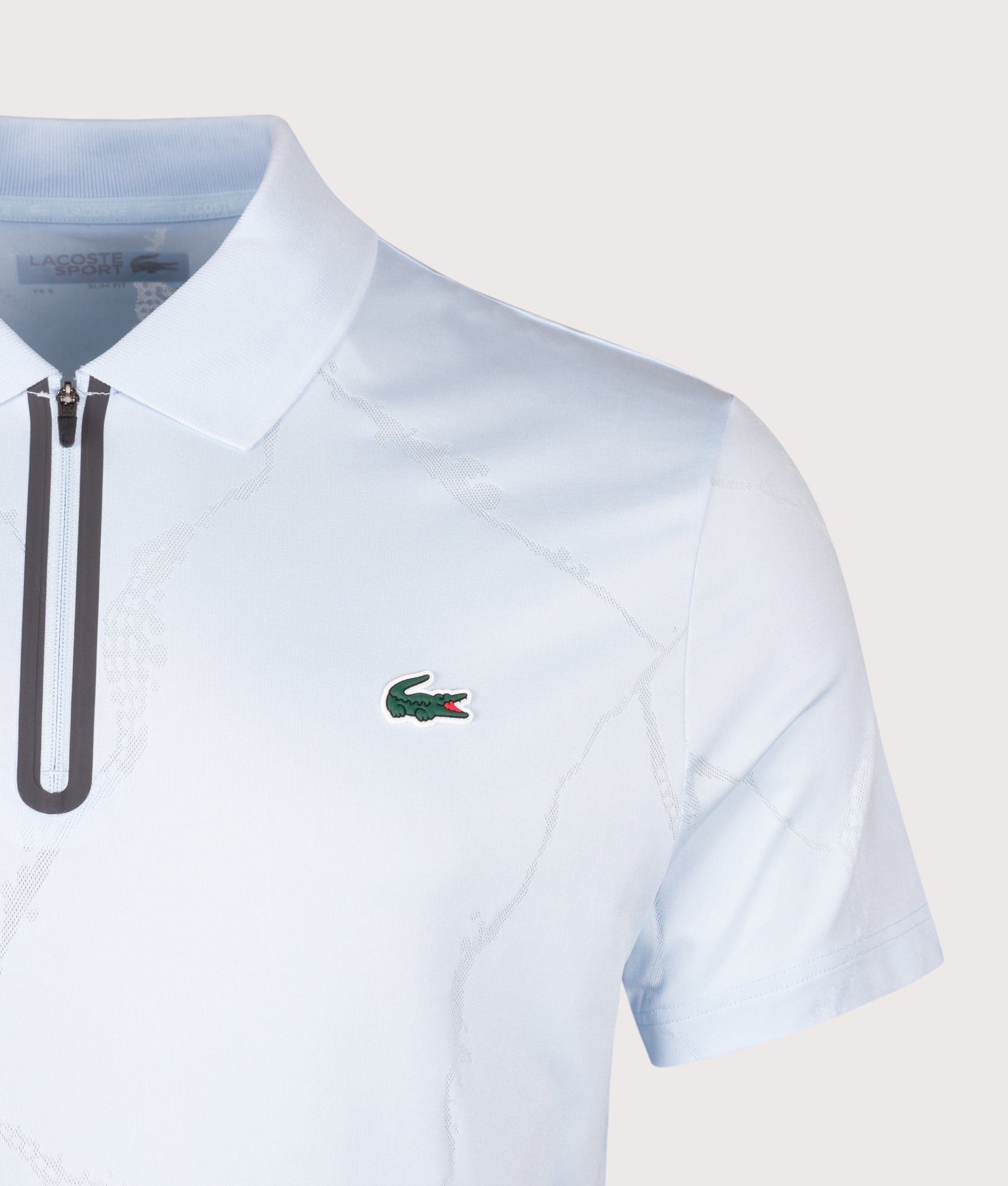 Lacoste Slim Fit Ultra Dry Jacquard Crocodile Tennis Polo Shirt in Sugared Blue at EQVVS Menswear. Detail shot.