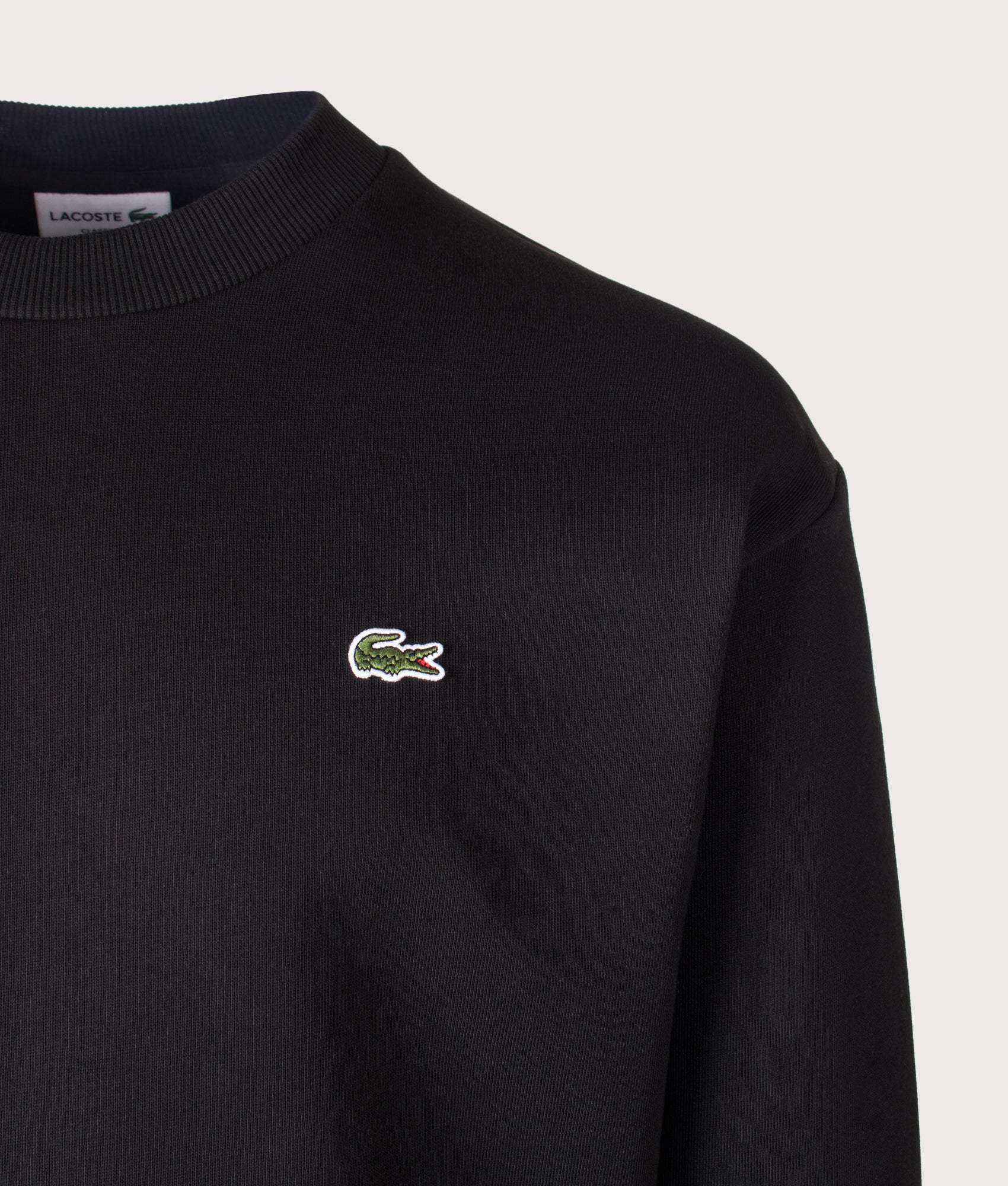 Lacoste Classic Fit Crewneck Sweatshirt in Black at EQVVS Menswear. Detail shot.