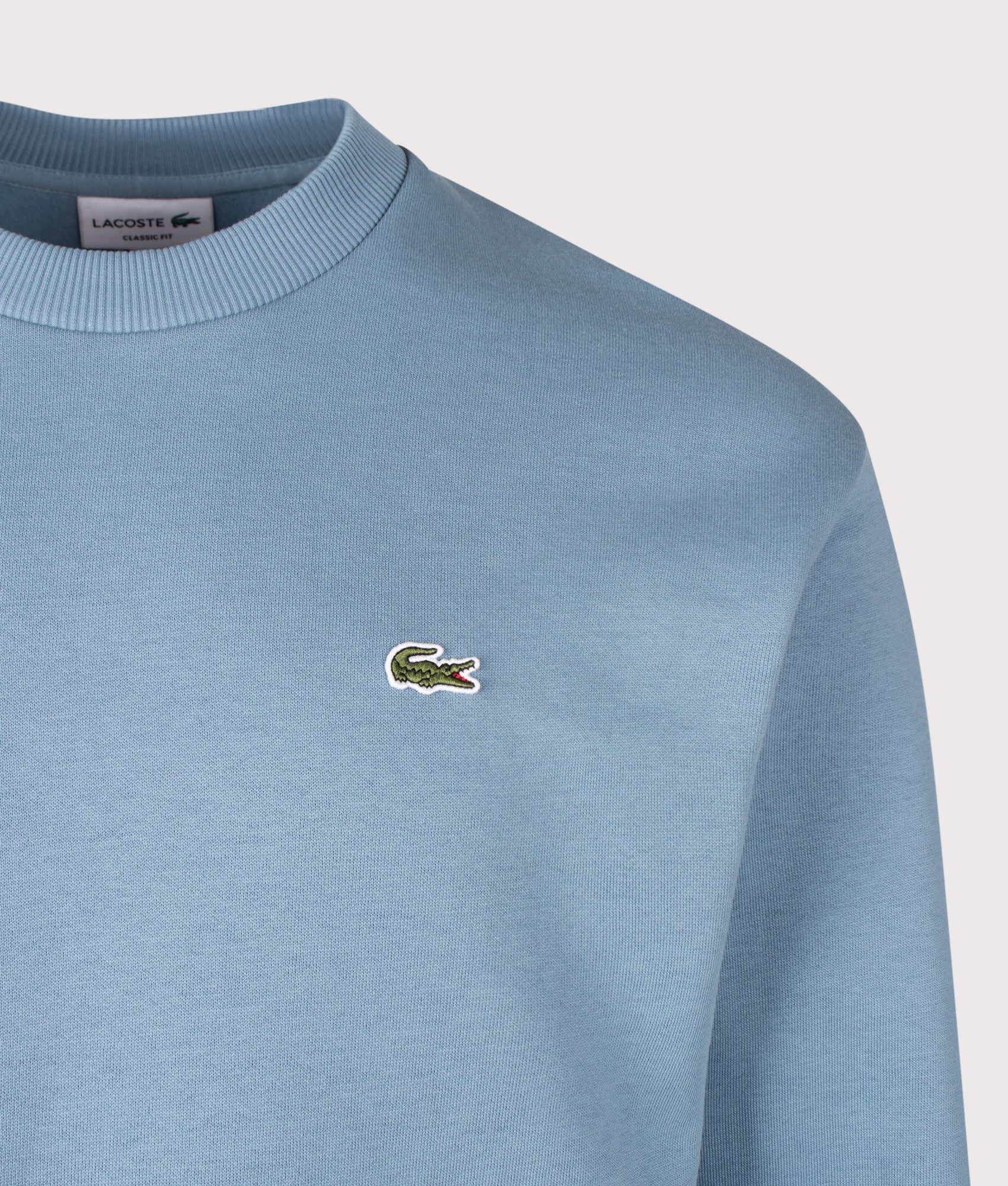 Lacoste Classic Fit Round Neck Sweatshirt in Aral at EQVVS Menswear. Detail shot.