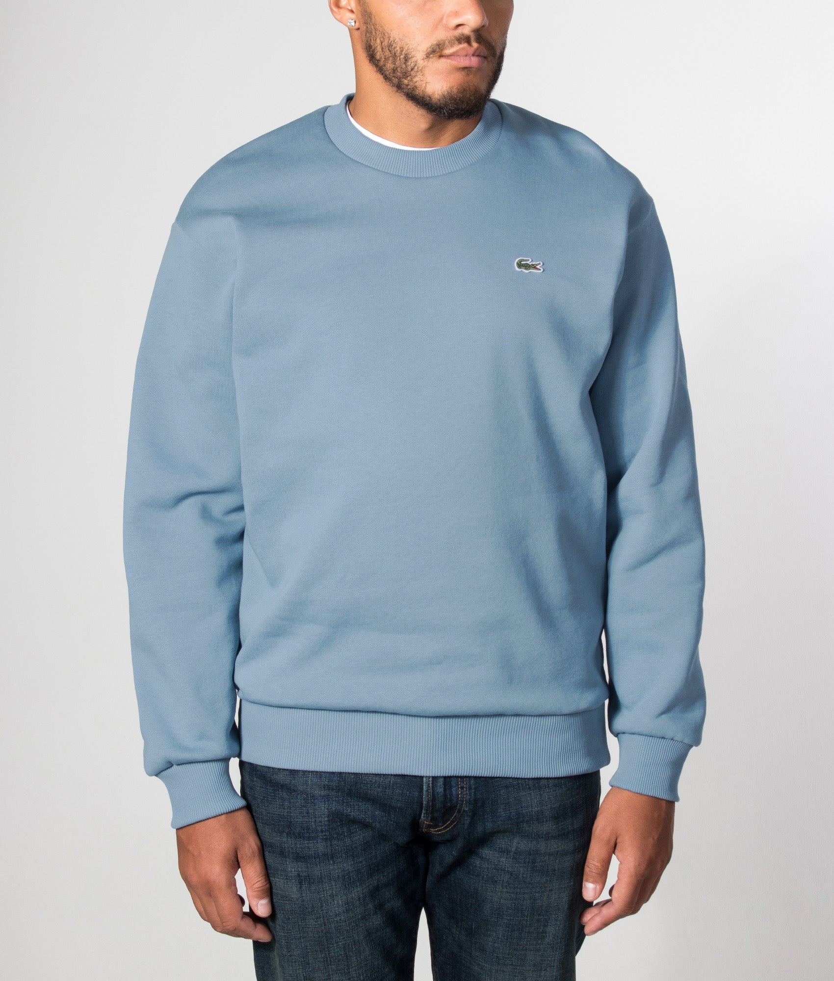Lacoste Classic Fit Round Neck Sweatshirt in Aral at EQVVS Menswear. Model front shot.