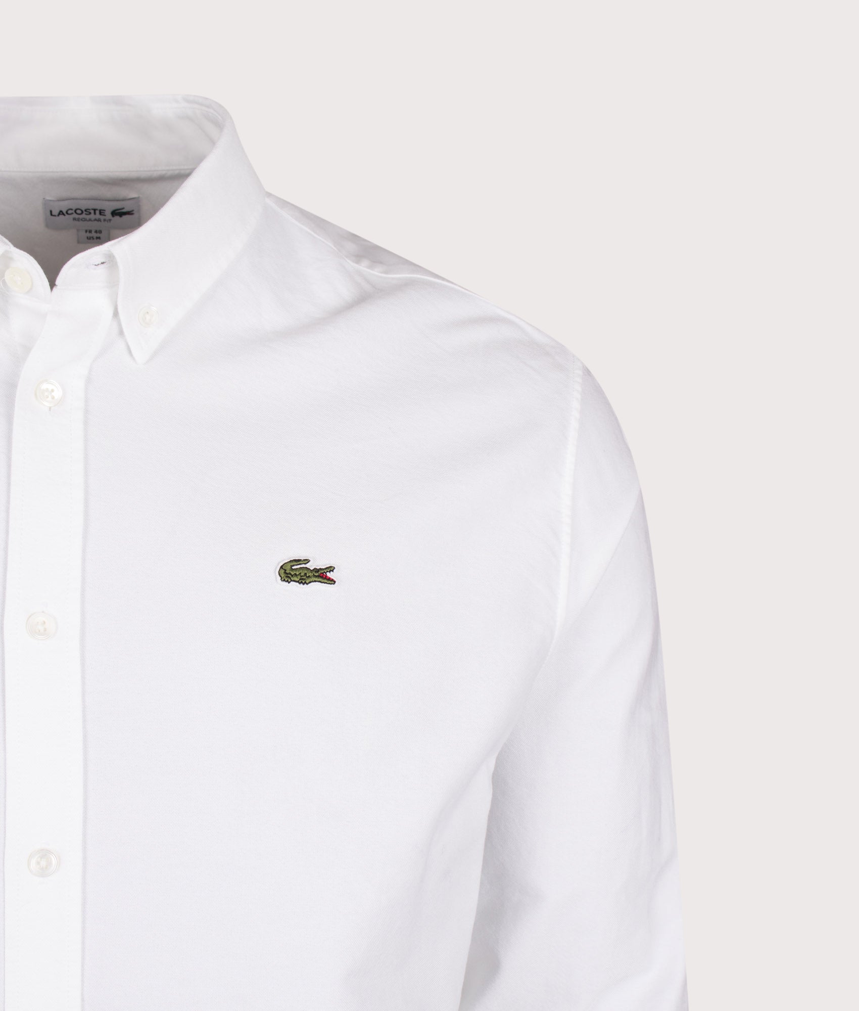 Lacoste Regular Fit Oxford Shirt in White at EQVVS Menswear. Detail shot.