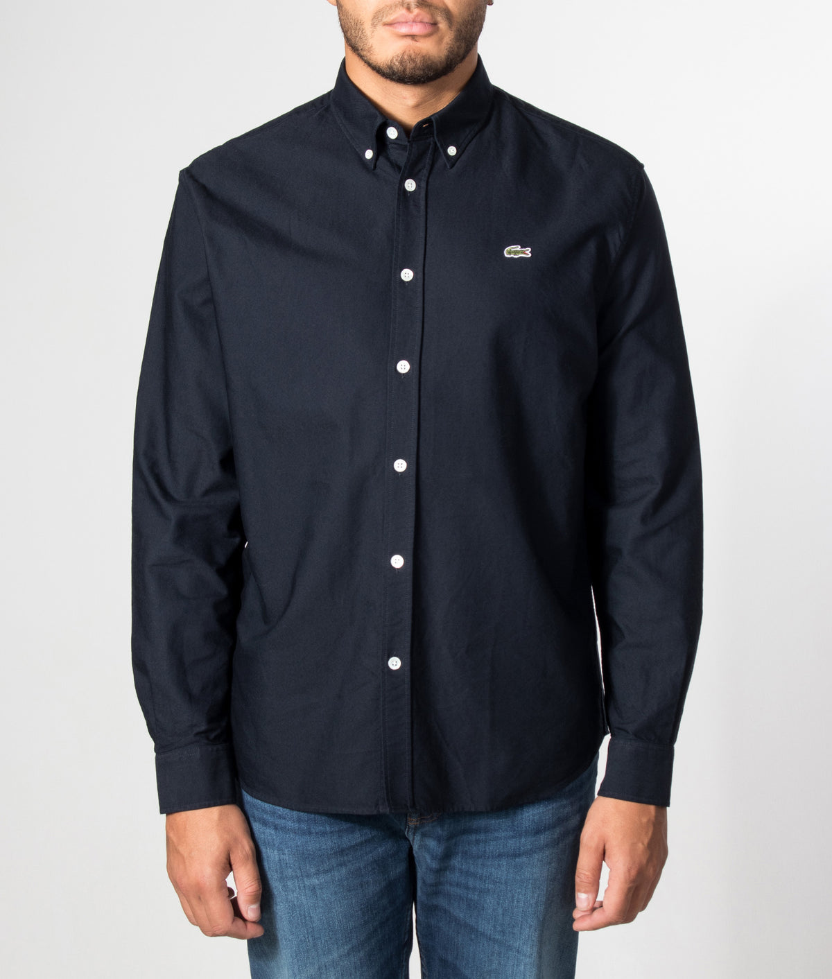 Lacoste Regular Fit Oxford Shirt arrives in Abysm at EQVVS Menswear. Model front shot.