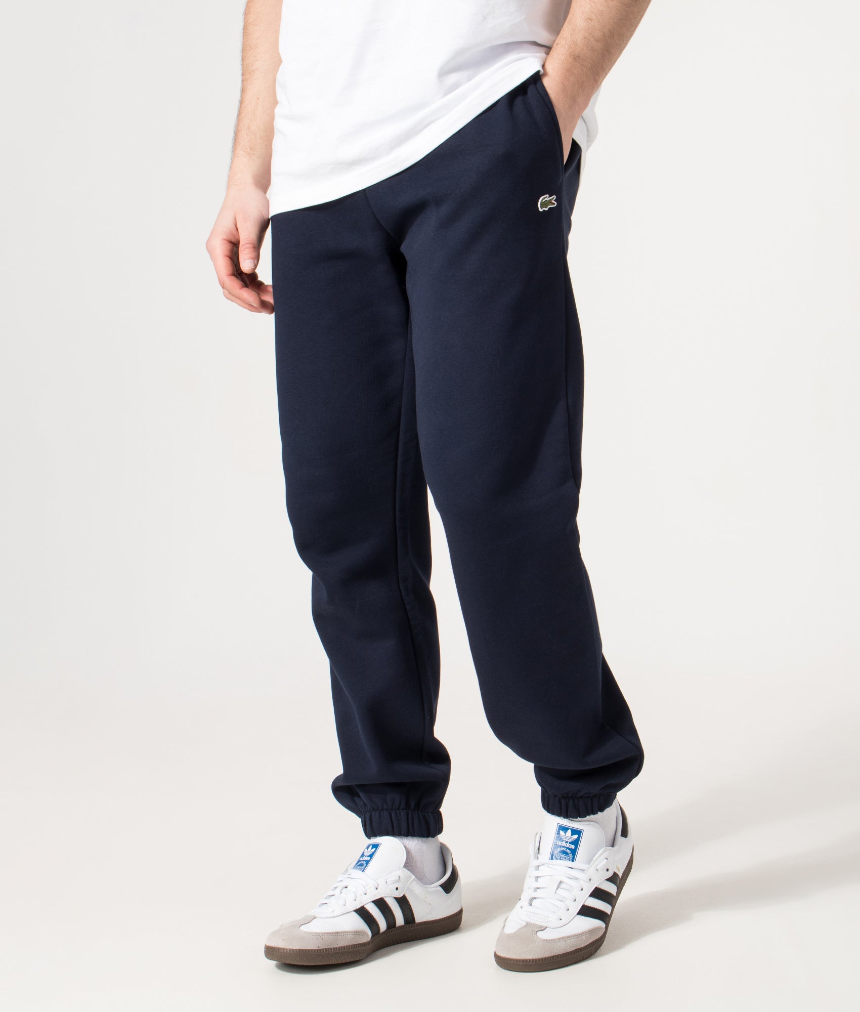 Lacoste Regular Fit Brushed Fleece Joggers in Navy Blue at EQVVS Menswear. Angled model front shot.