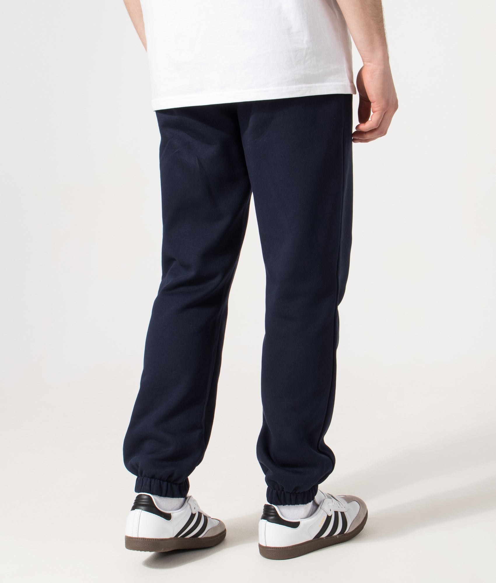 Lacoste Regular Fit Brushed Fleece Joggers in Navy Blue at EQVVS Menswear. Angled model back shot.