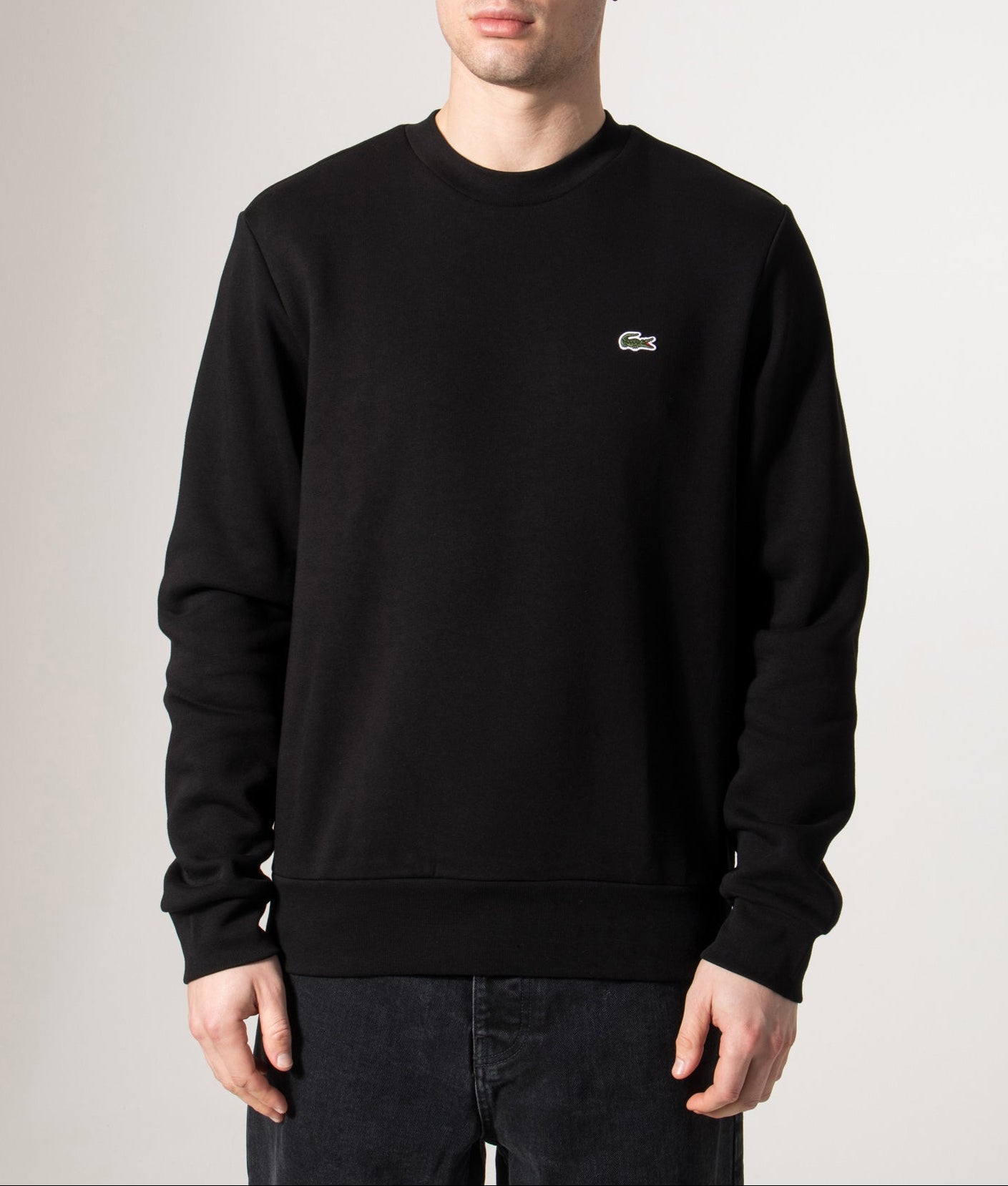 Lacoste Relaxed Fit Brushed Cotton Sweatshirt in Black at EQVVS Menswear. Model front shot.