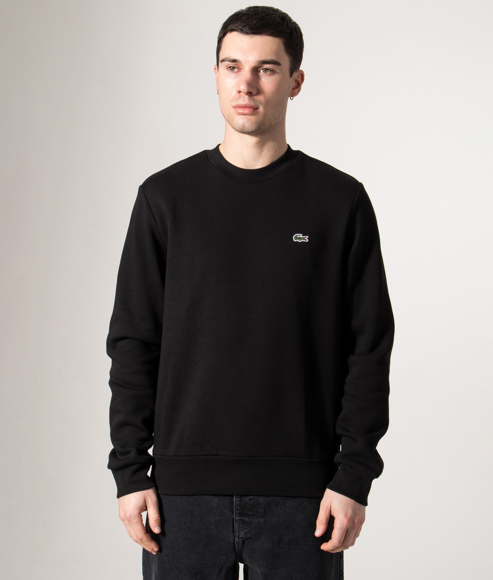 Lacoste Relaxed Fit Brushed Cotton Sweatshirt in Black at EQVVS Menswear. Model front shot.