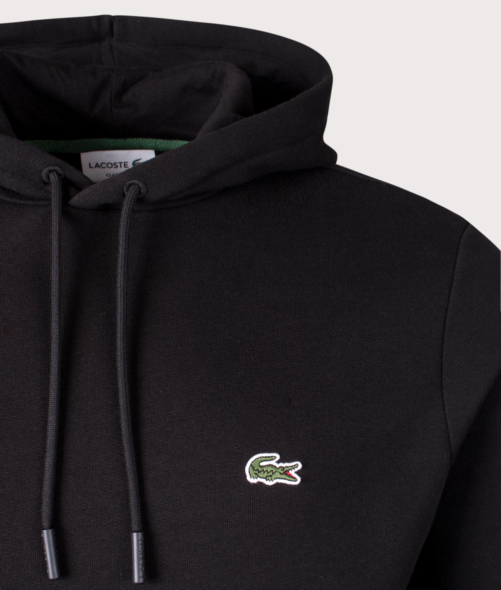 Lacoste Relaxed Fit Brushed Fleece Hoodie in Black at EQVVS Menswear. Detail shot.