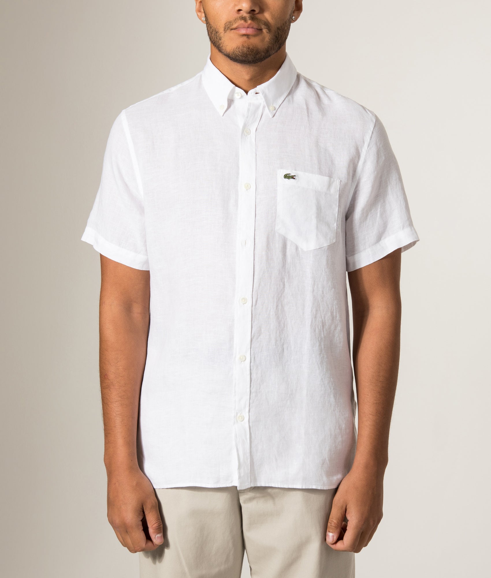 Lacoste Short Sleeve Linen Shirt in White at EQVVS Menswear. Model front shot.