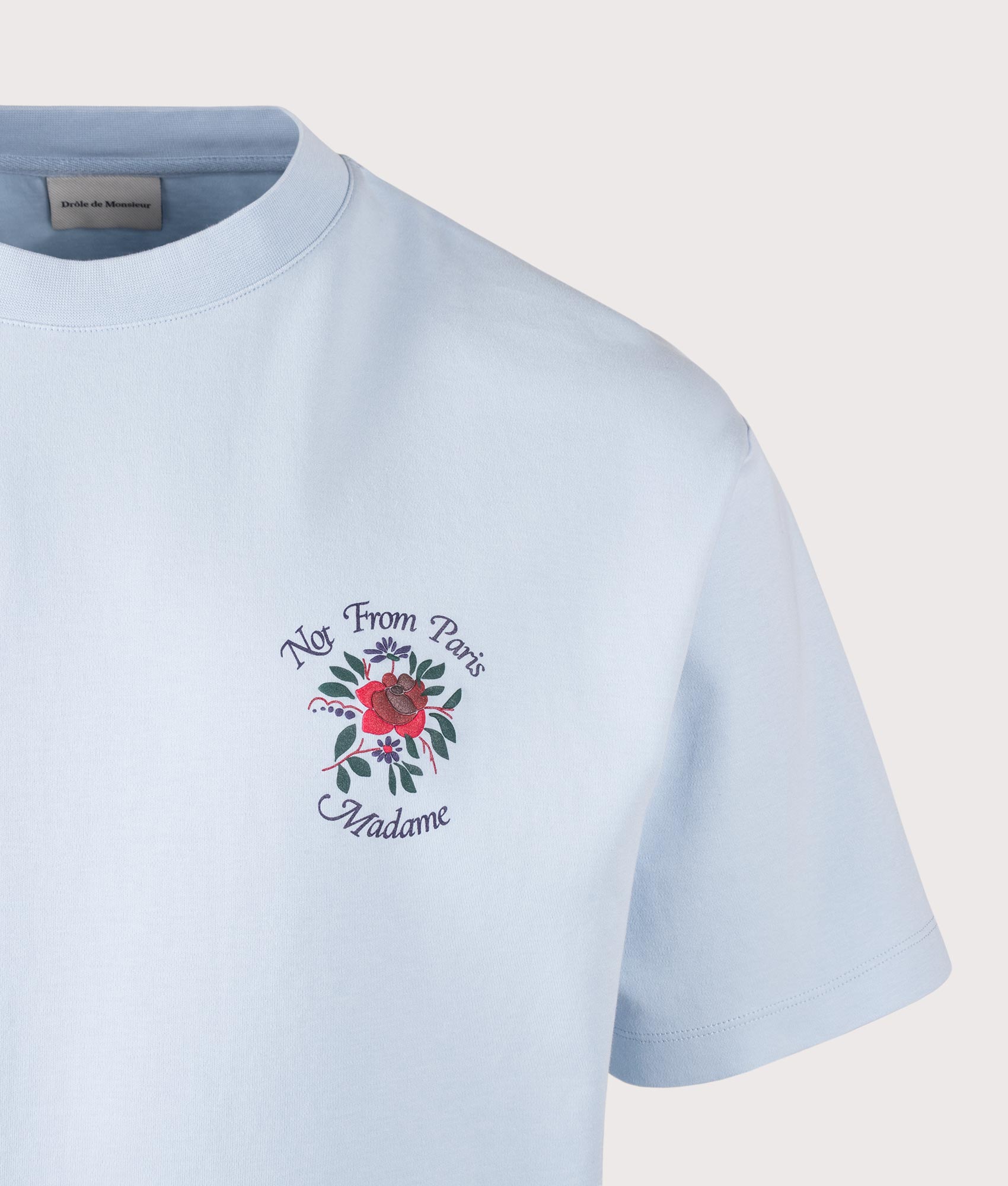 Drôle de Monsieur Slogan Rose T-Shirt in Light Blue at EQVVS Menswear. Detail shot.