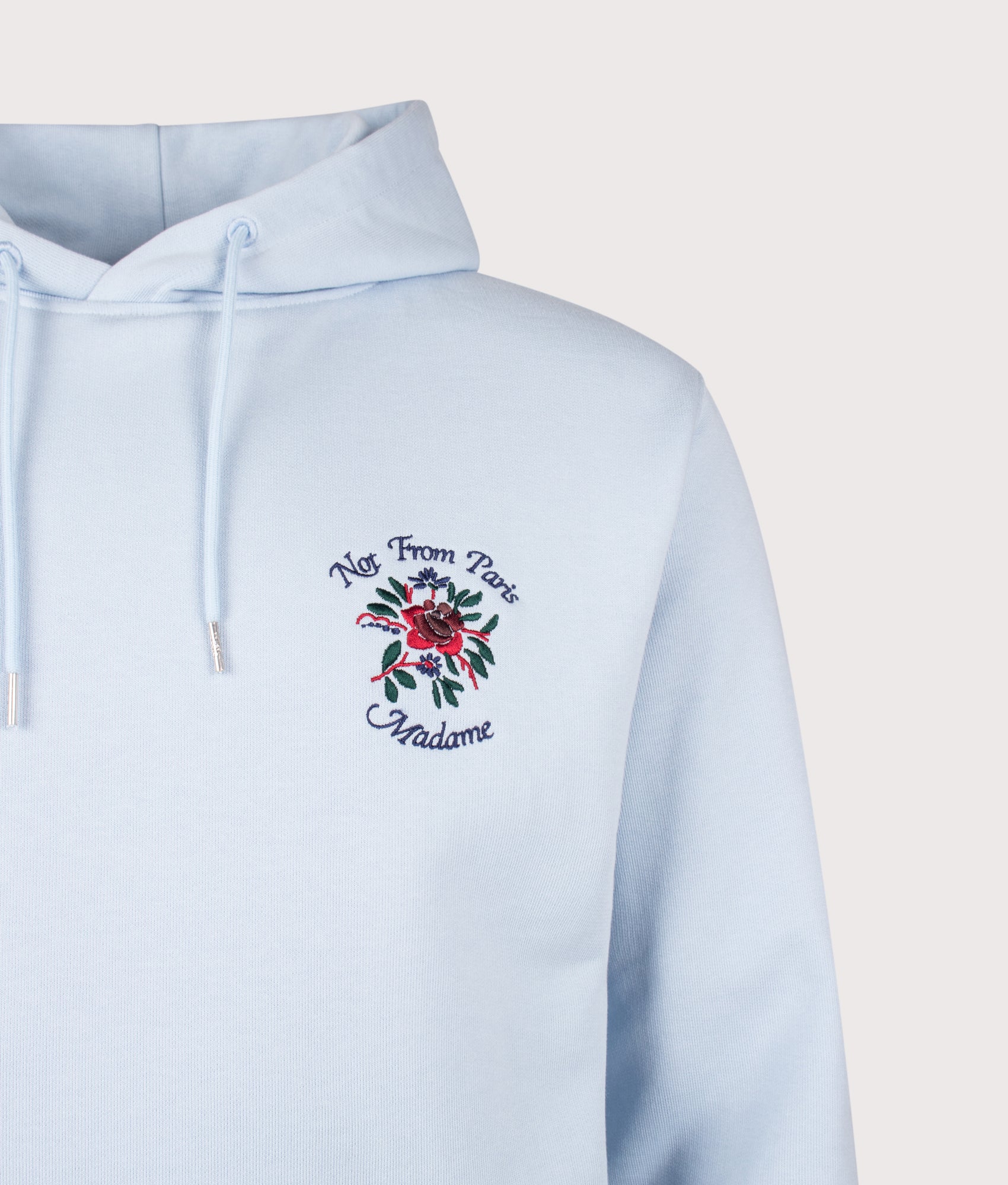 Slogan Rose Hoodie in Light Blue by Drôle de Monsieur. Shot by EQVVS. Detail shot.