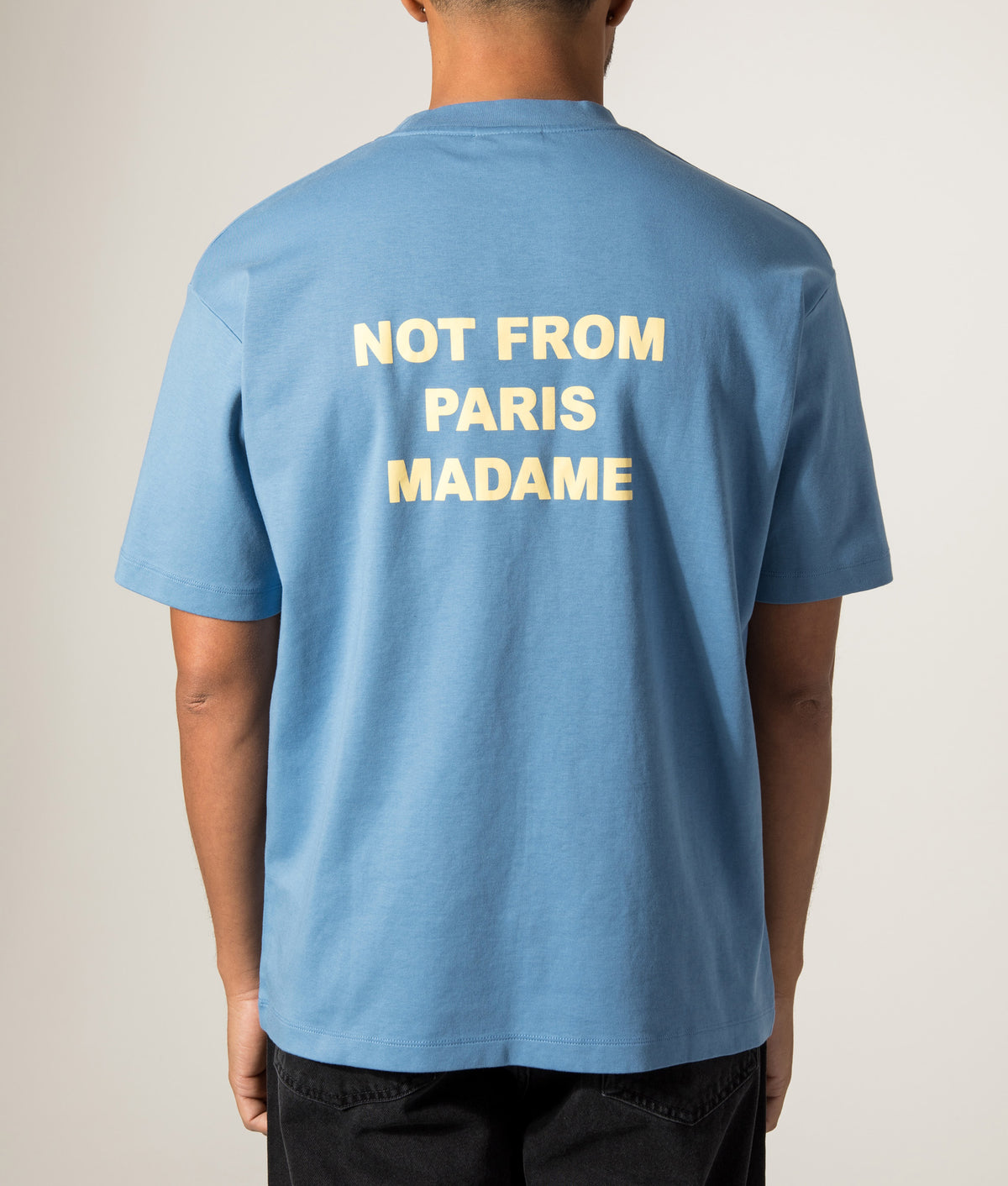 Drôle de Monsieur Relaxed Fit Slogan T-Shirt in Atlantic Blue at EQVVS Menswear. Model back shot.